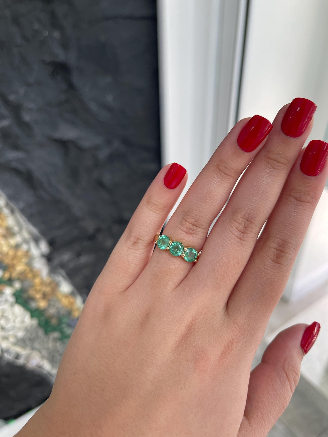 Ladies 2.20 Carat round emerald three-stone band ring in 14K gold with prong setting, featuring rich green Colombian emeralds.