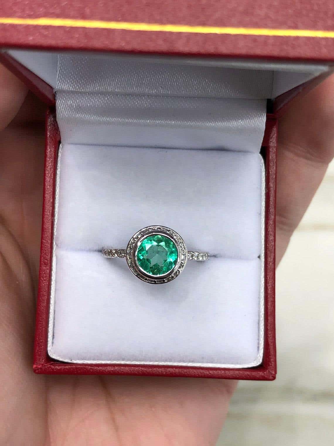 Round Colombian emerald diamond halo engagement ring in 14K gold with 1.60 carats, featuring a stunning central emerald.