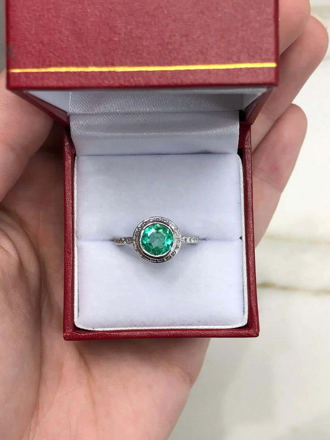 Round 1.60 Carat Colombian emerald diamond halo engagement ring in 14K gold featuring a central emerald with diamond accents.