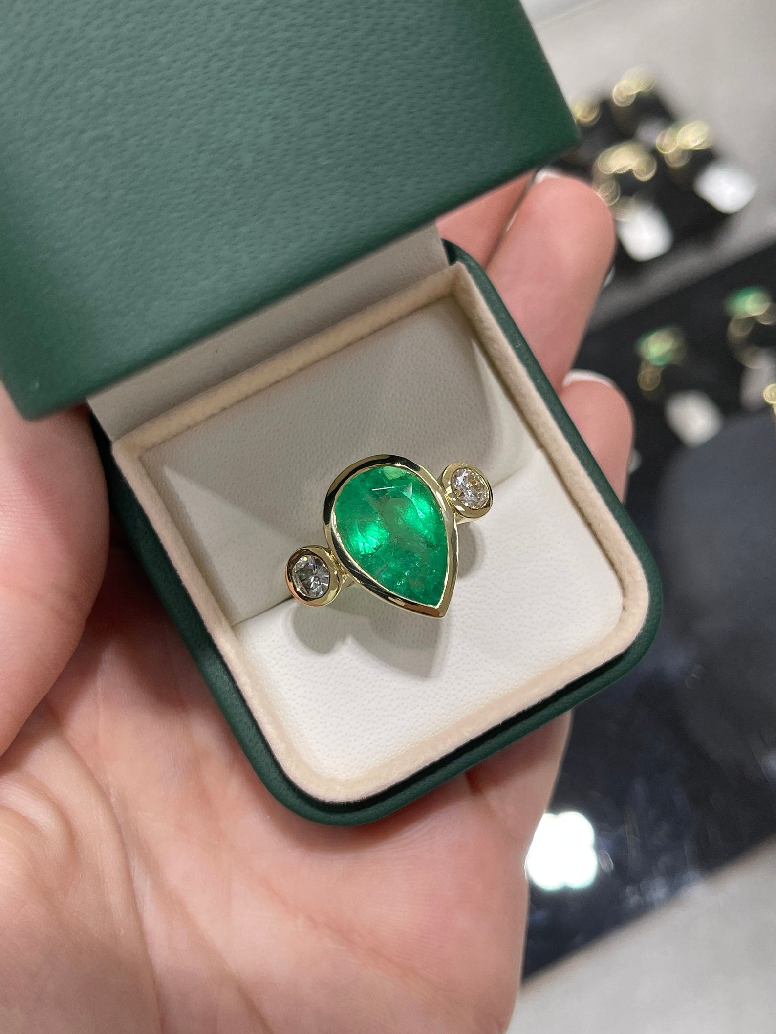 8.0 Carat pear-shaped Colombian emerald diamond three-stone engagement ring in 18K bezel setting by JR Colombian Emeralds