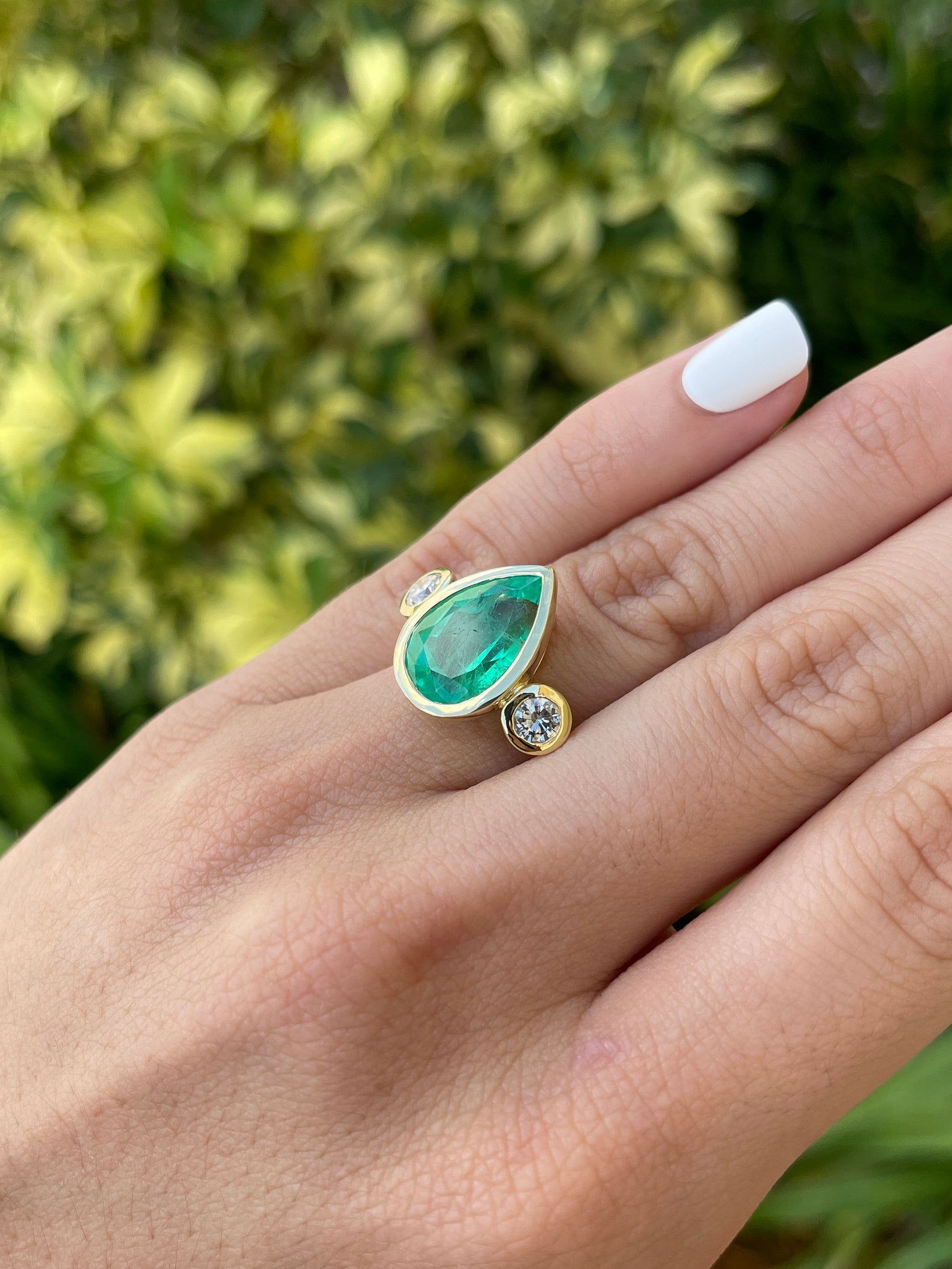8.0 Carat pear-shaped Colombian emerald diamond three-stone engagement ring in 18K bezel set by JR Colombian Emeralds.
