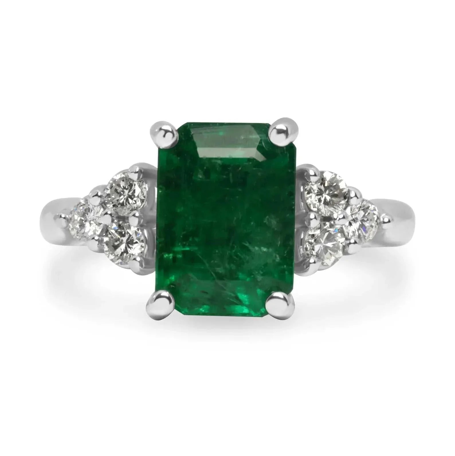 Emerald and diamond cluster engagement ring with 3.34-carat emerald center and six round diamonds in 14K two-tone gold setting