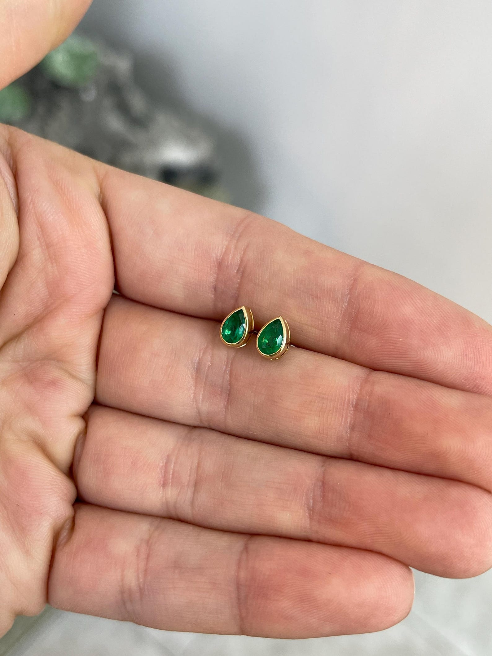 Rich green pear cut Zambian emerald stud earrings with bezel setting by JR Colombian Emeralds.
