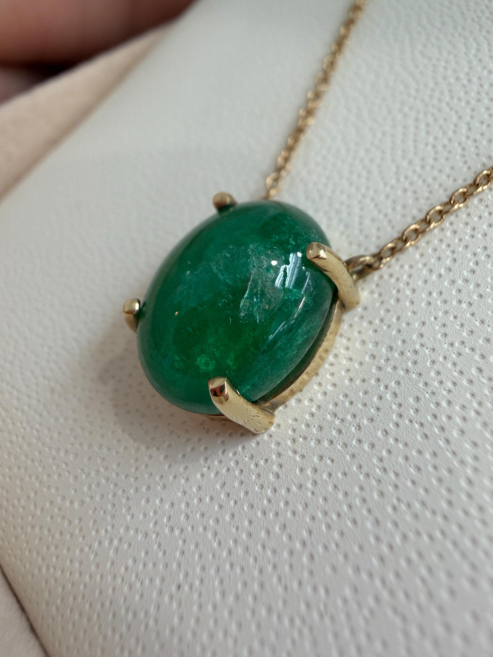 14K gold necklace featuring a 5.50tcw Zambian emerald cabochon pendant with prong station setting.