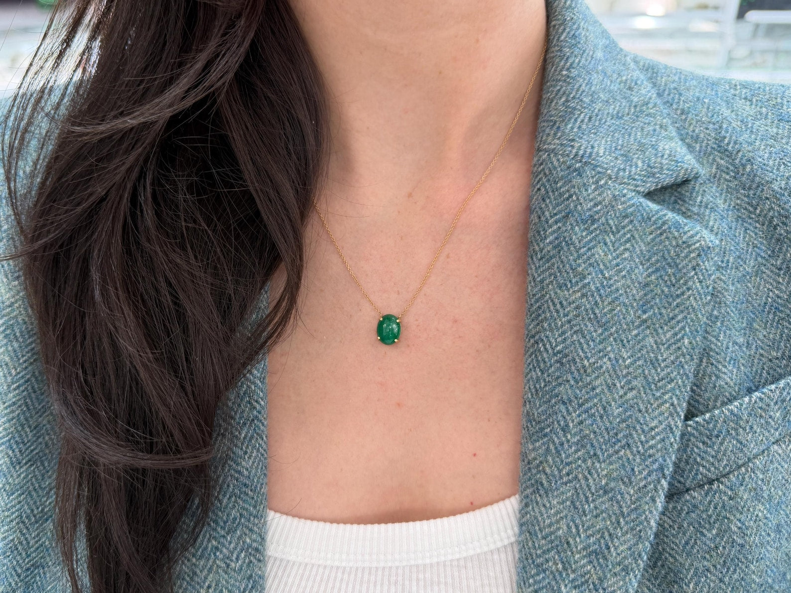 Zambian emerald cabochon pendant on a 14K gold necklace, featuring prong station design by JR Colombian Emeralds.