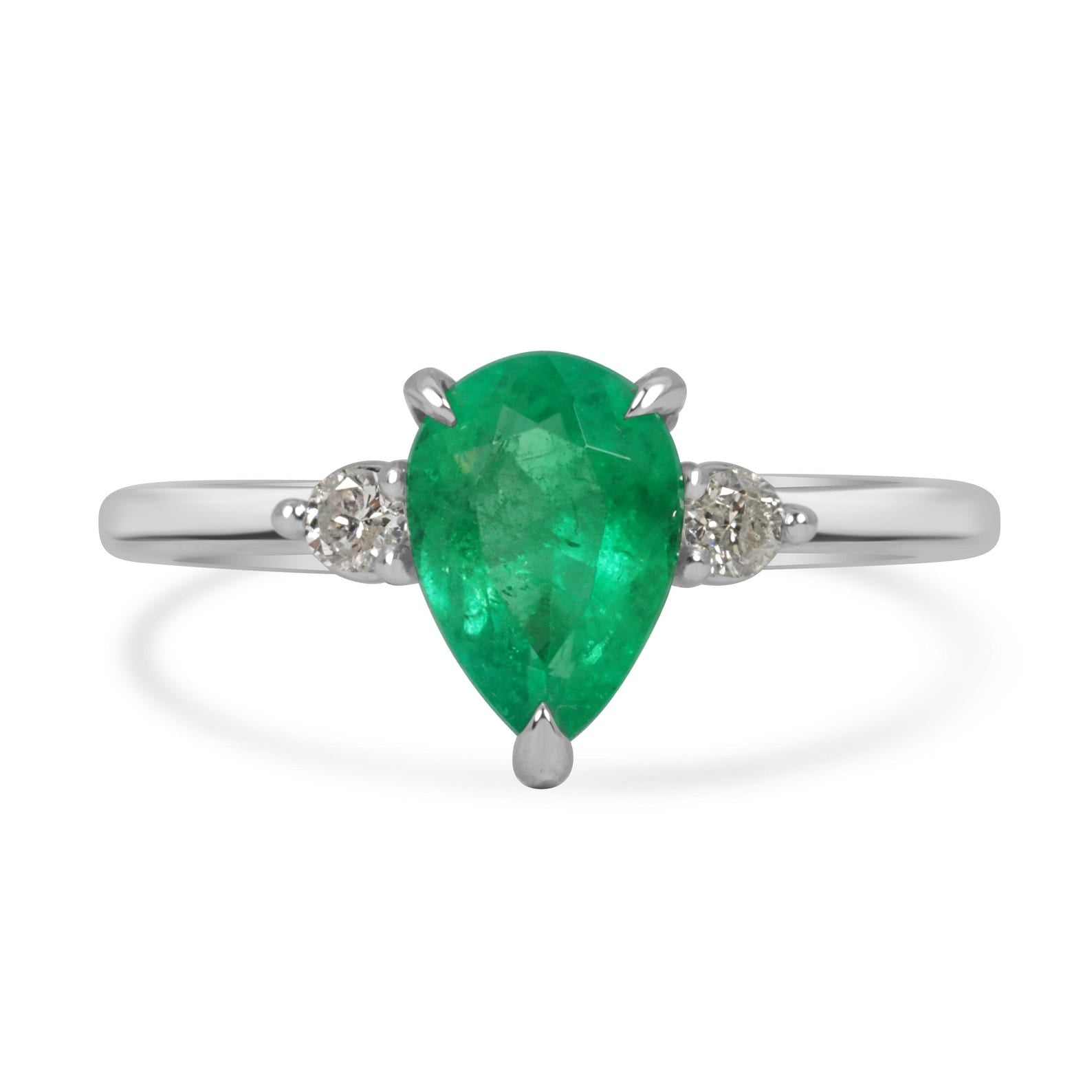 Pear-shaped Colombian emerald three-stone engagement ring with platinum prong setting, featuring sparkling green gemstones.