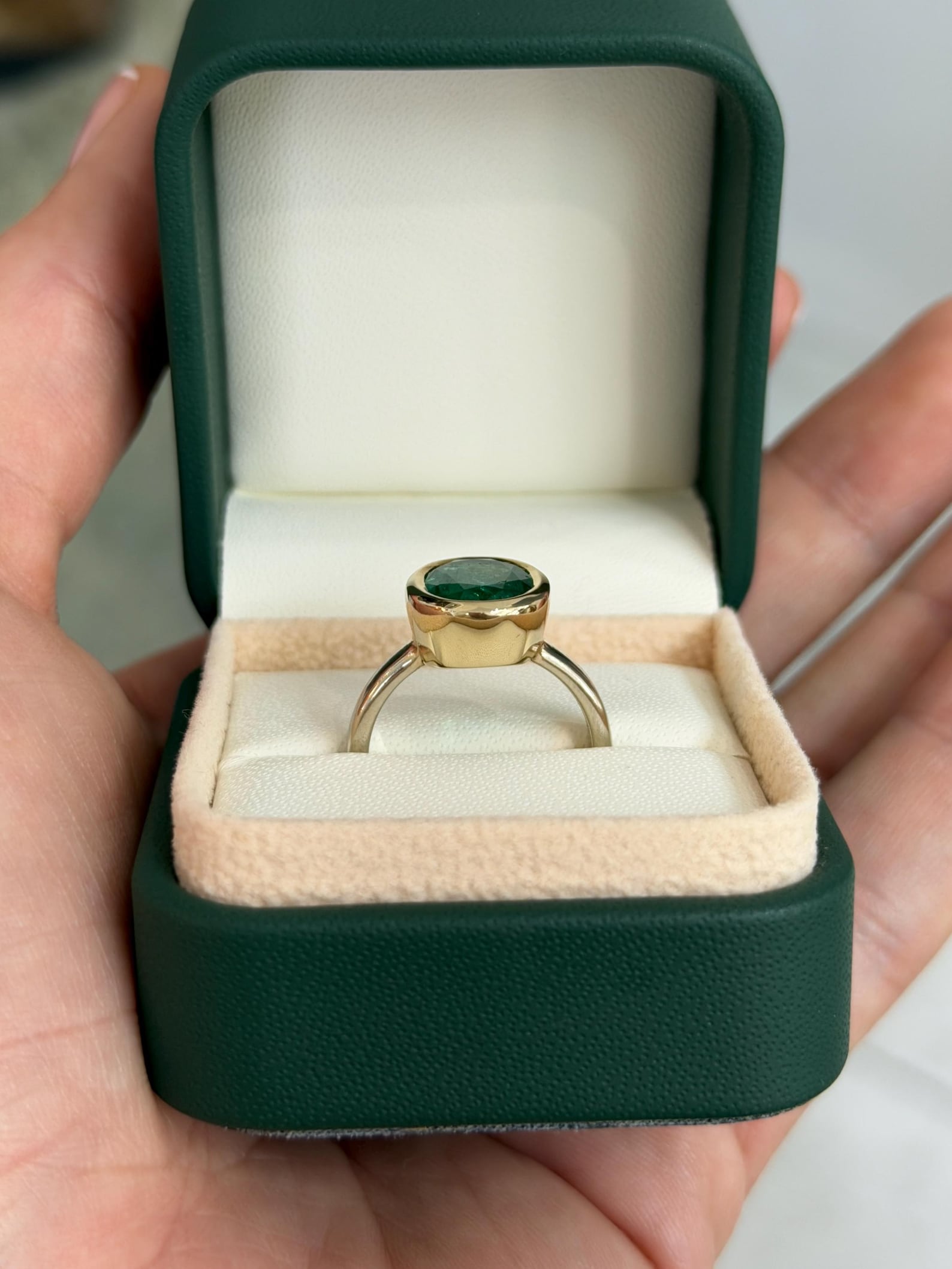 Emerald engagement ring featuring a 3.85 carat oval cut emerald in a two-toned 585 gold bezel setting by JR Colombian Emeralds