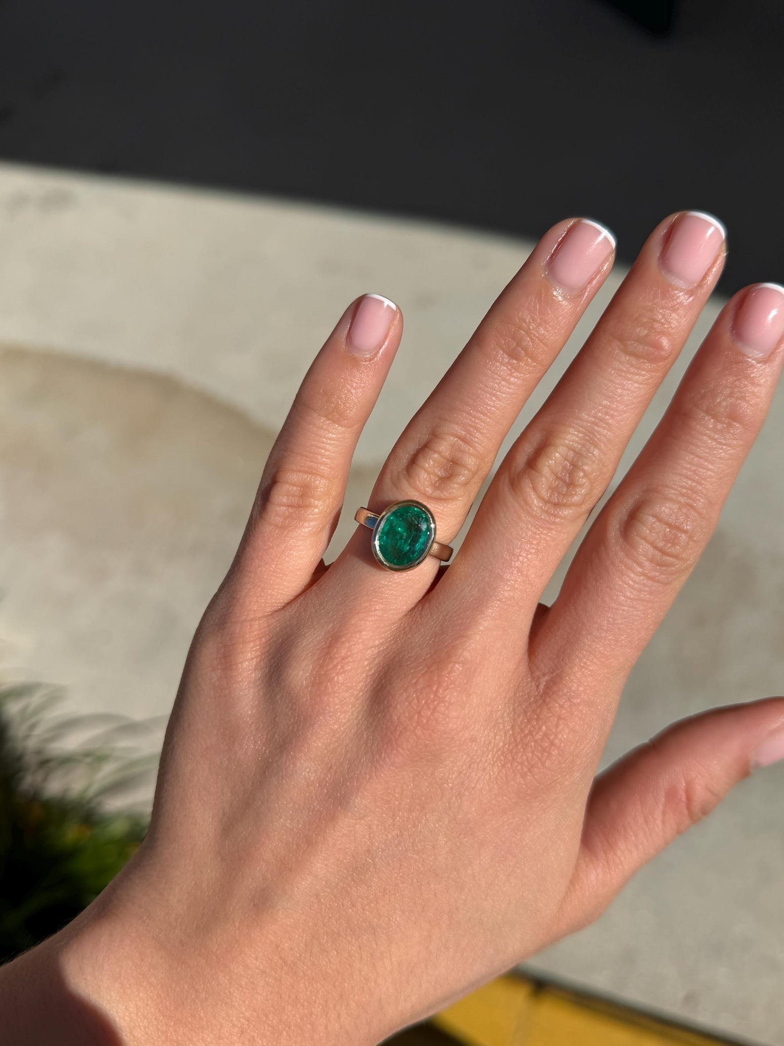 Emerald engagement ring with a 3.85 carat oval cut emerald, two-toned bezel set in 585 gold, by JR Colombian Emeralds.