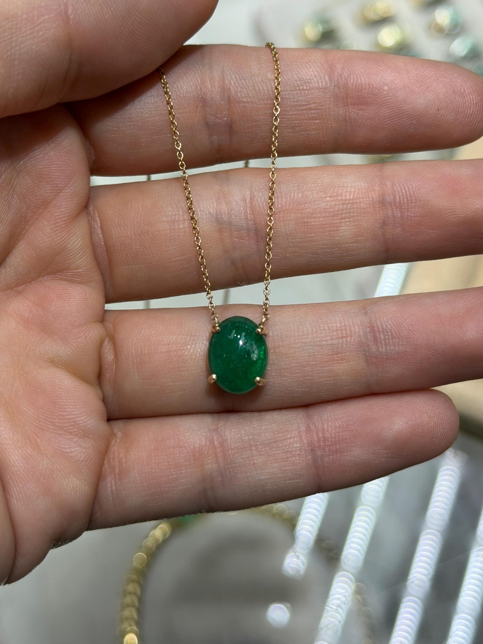 Zambian emerald cabochon pendant on a 14K gold necklace featuring prong station setting, jewelry by JR Colombian Emeralds.