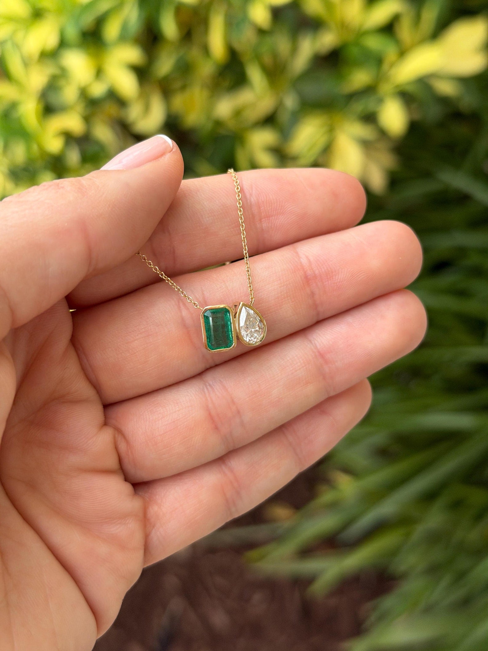 Emerald Moissanite Toi Et Moi pendant necklace in 14K gold with two emerald-cut stones, jewelry by JR Colombian Emeralds.