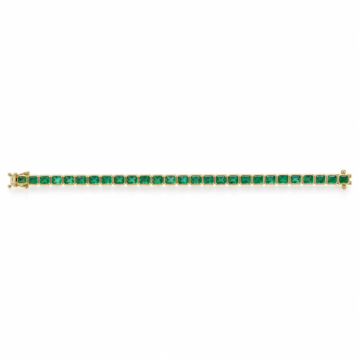 14K gold East to West bezel set emerald tennis bracelet with 6.69 carats of Colombian emeralds, featuring a sleek, elegant design.