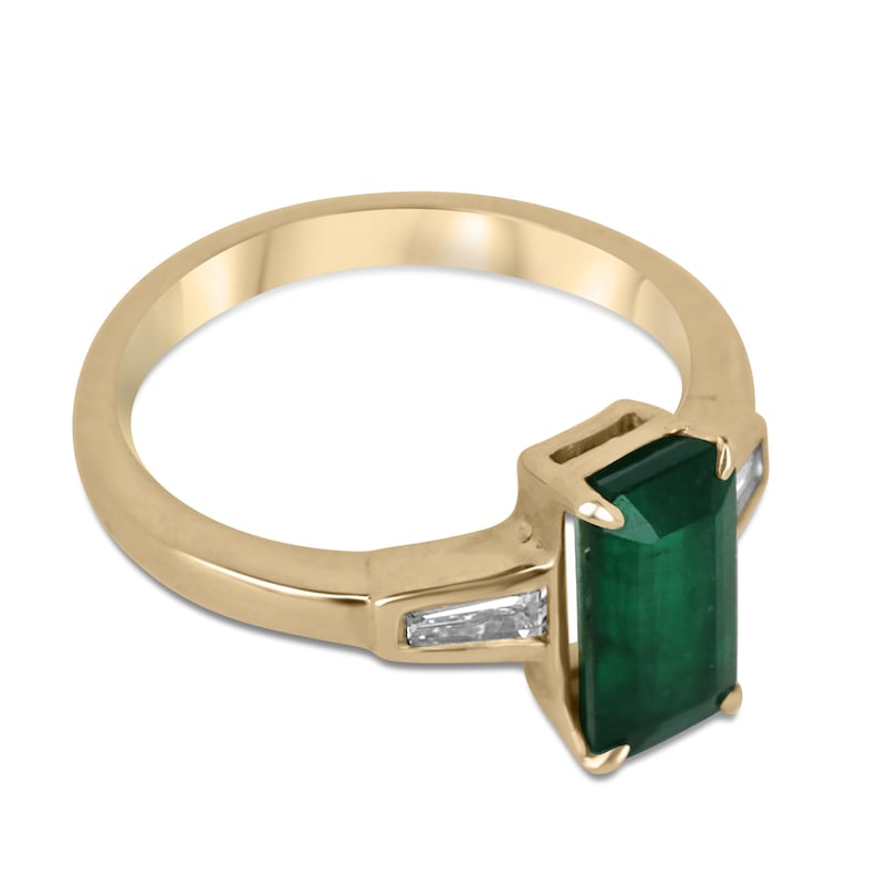 14K gold 3-stone engagement ring with dark green emerald and tapered baguette diamond accents, featuring a 2.45tcw gemstone.