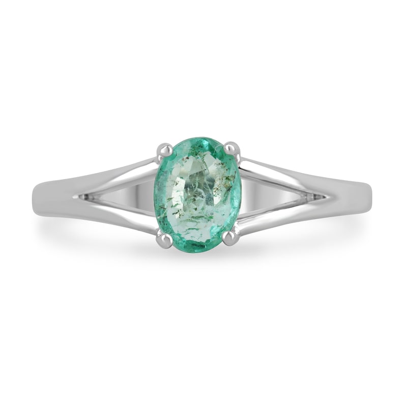 0.70 carat oval cut natural emerald split shank sterling silver ring with light spring green stone