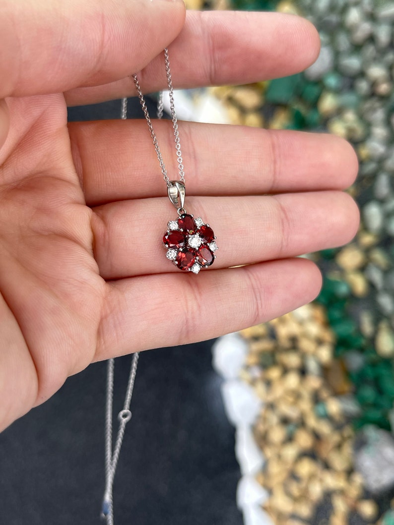 Stunning 14K White Gold Pendant Adorned with a 1.17tcw Dark Orangy-Red Garnet and Brilliantly Cut Diamond Accents in a Floral Design
