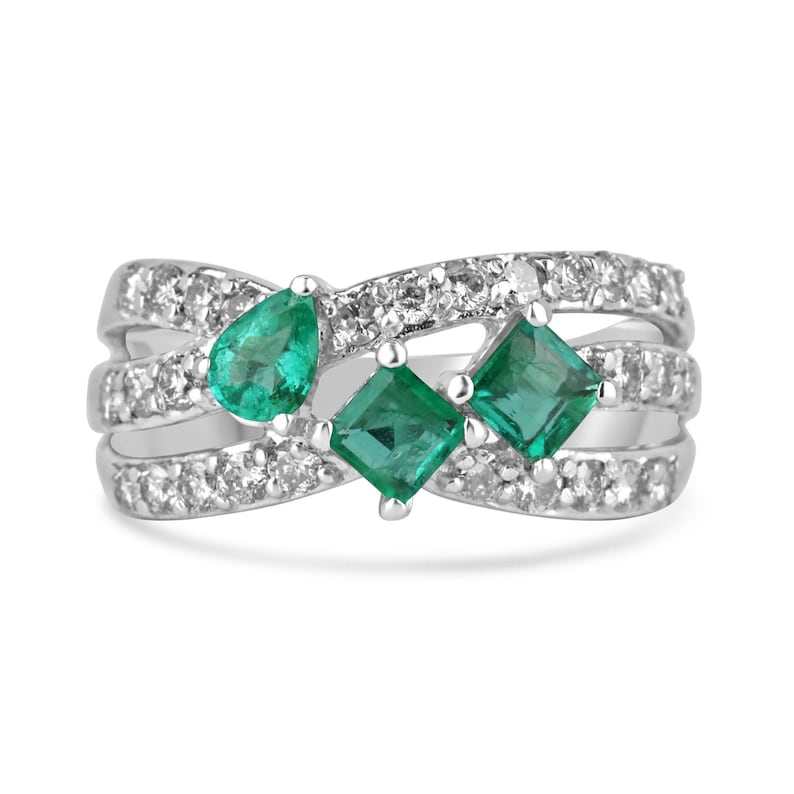 14K white gold Emerald and Diamond Accent Ring with three stones including princess and pear cut emeralds and diamond pave shank