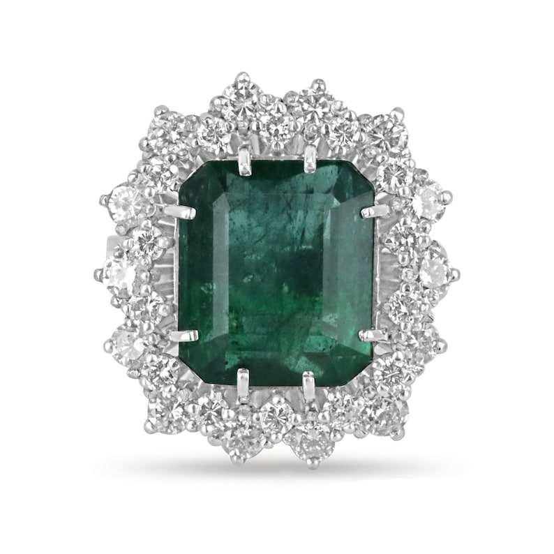 Vintage emerald and diamond cocktail ring with deep green emerald cut emerald and double diamond halo in platinum setting