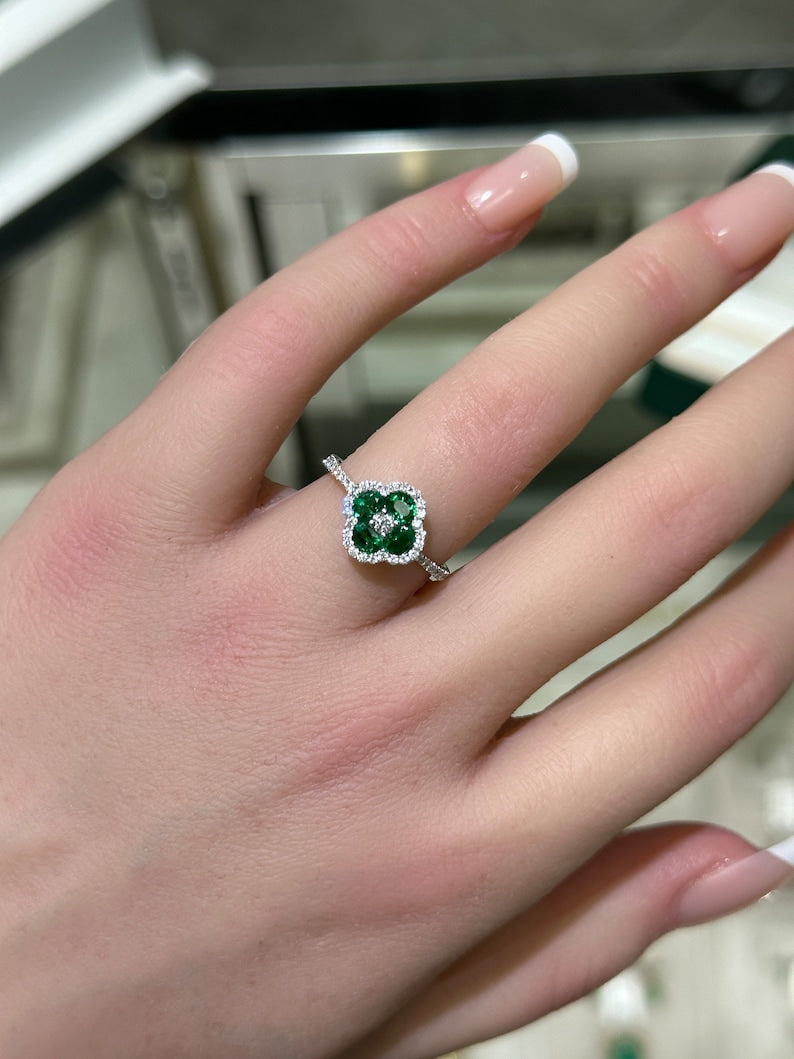 Elegant 14K White Gold Ring Featuring a 0.95 Carat Oval Emerald and Diamond Halo