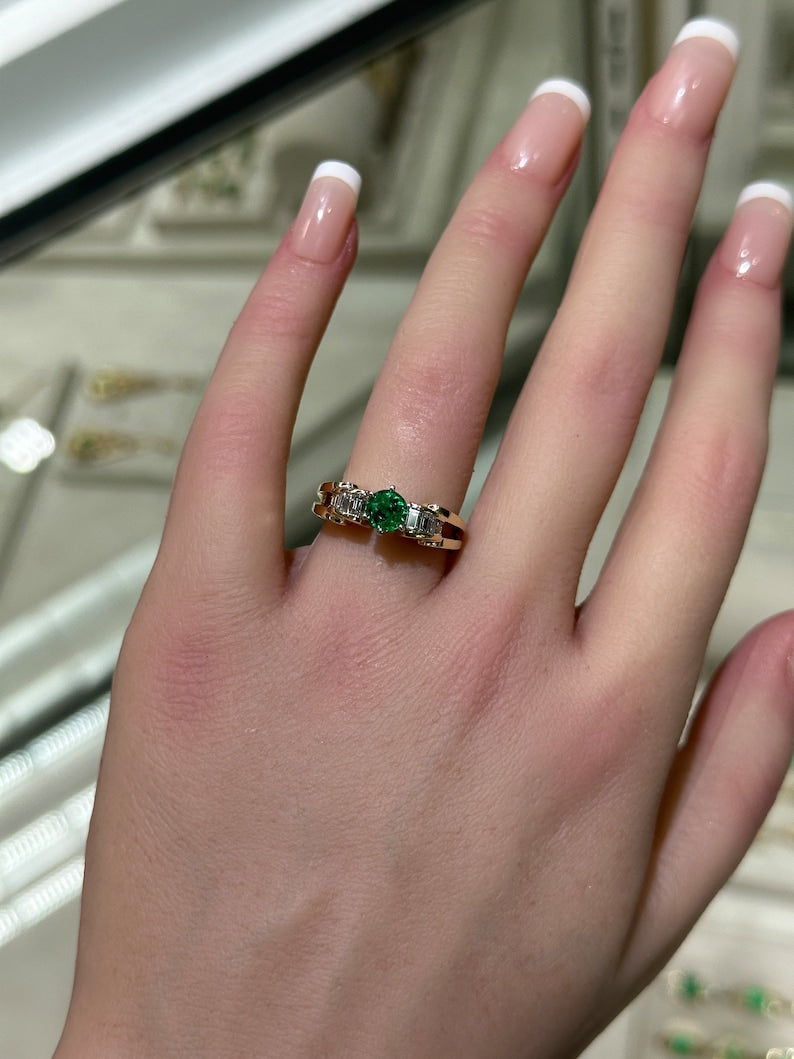 14K gold engagement ring with 1.25tcw Colombian emerald center and diamond baguette accents, 6-prong setting.