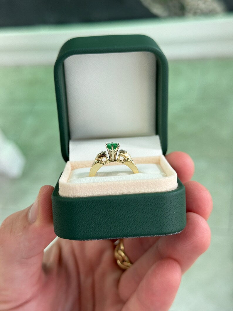 14K gold engagement ring with 1.25ctw Colombian emerald center stone and diamond baguette accents in a 6-prong setting.