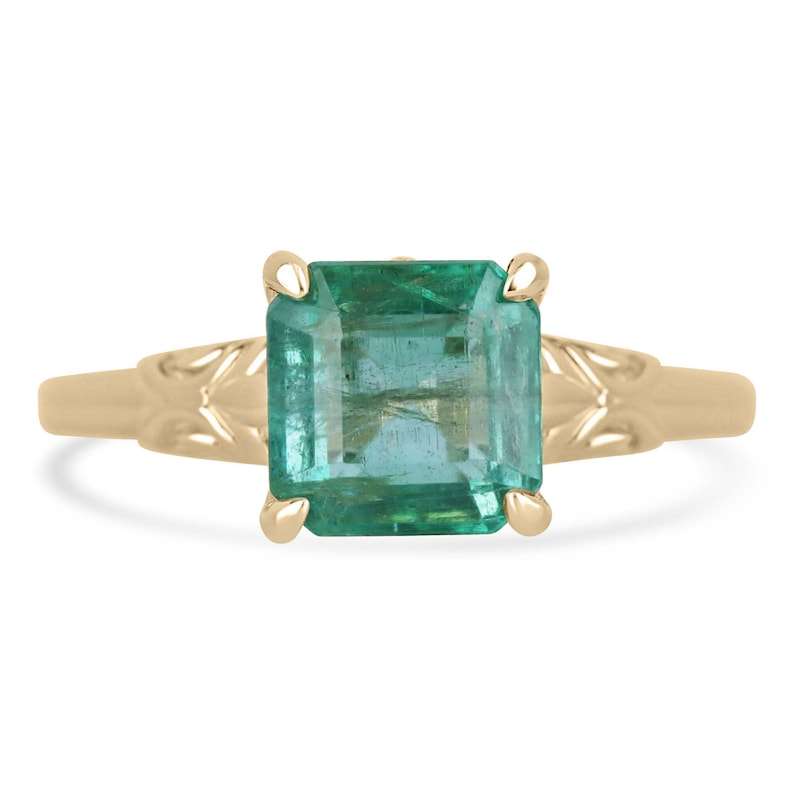 2.37ct emerald solitaire ring with floral four-prong setting in 14K gold.