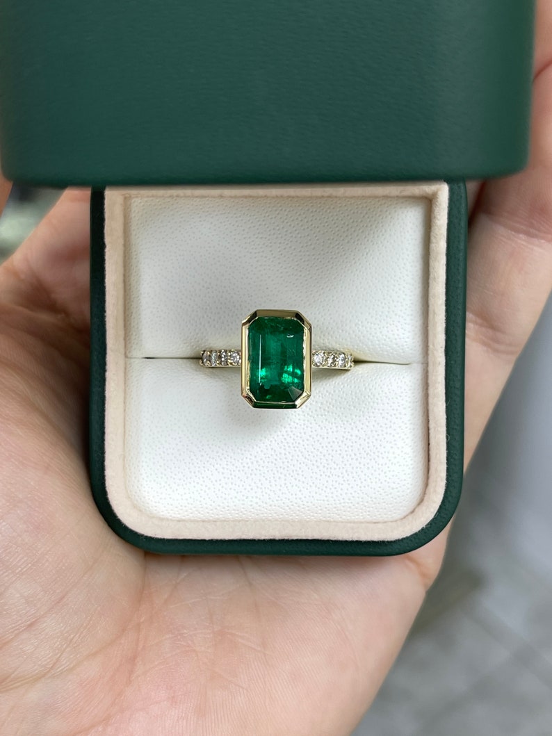 Green emerald cut engagement ring with diamond accents in 14K gold, featuring a 3.59 carat Colombian emerald.