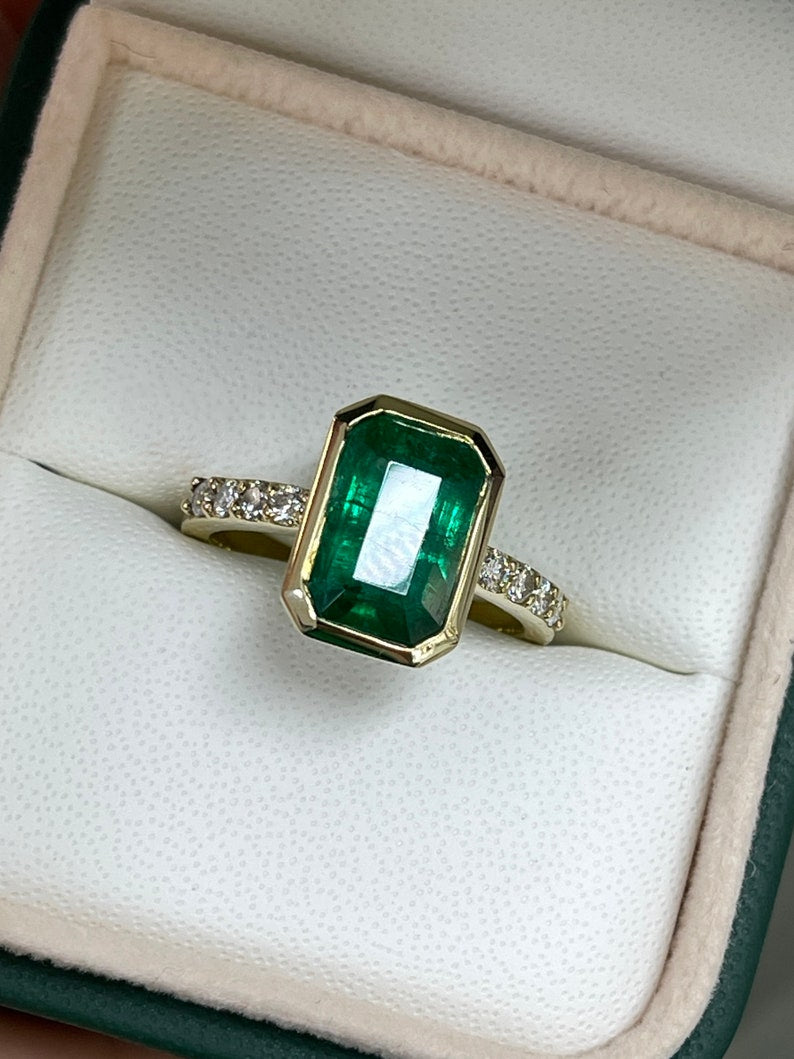Green emerald cut engagement ring with diamond accents in 14K gold, featuring a 3.59 carat Colombian emerald.