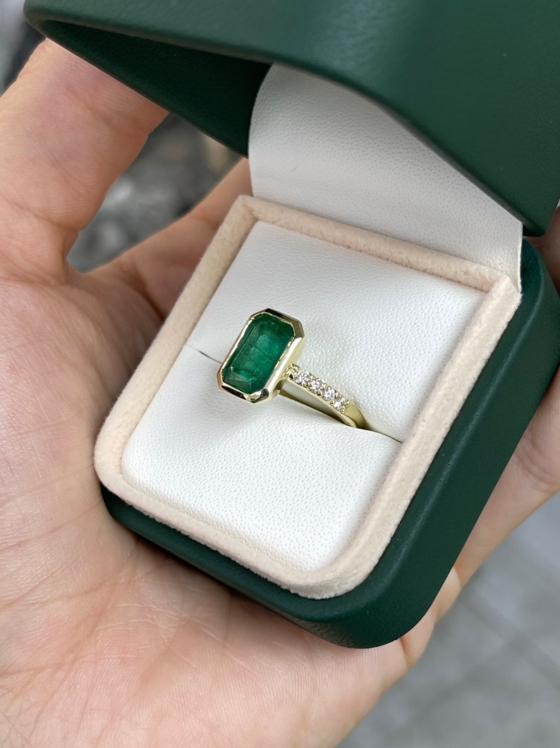 Green emerald cut engagement ring with diamond accents in 14K gold, featuring a 3.59tcw Colombian emerald.