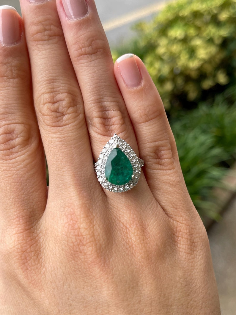 18K Gold Ring Showcasing 8.70tcw Pear Cut Emerald and Double Halo of Diamonds
