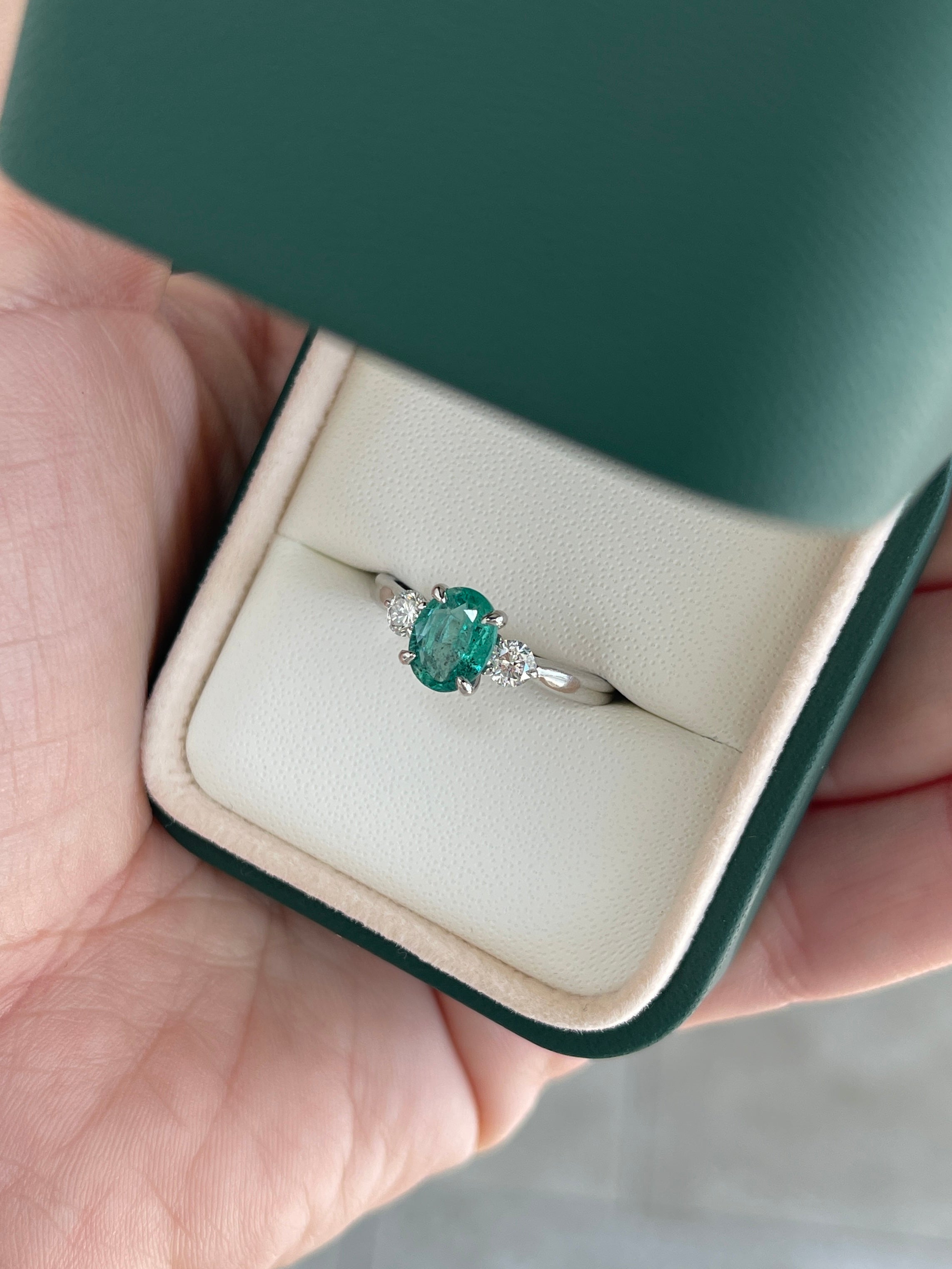 14K natural bluish-green oval cut emerald and round lab diamond three-stone ring by JR Colombian Emeralds, detailed close-up.
