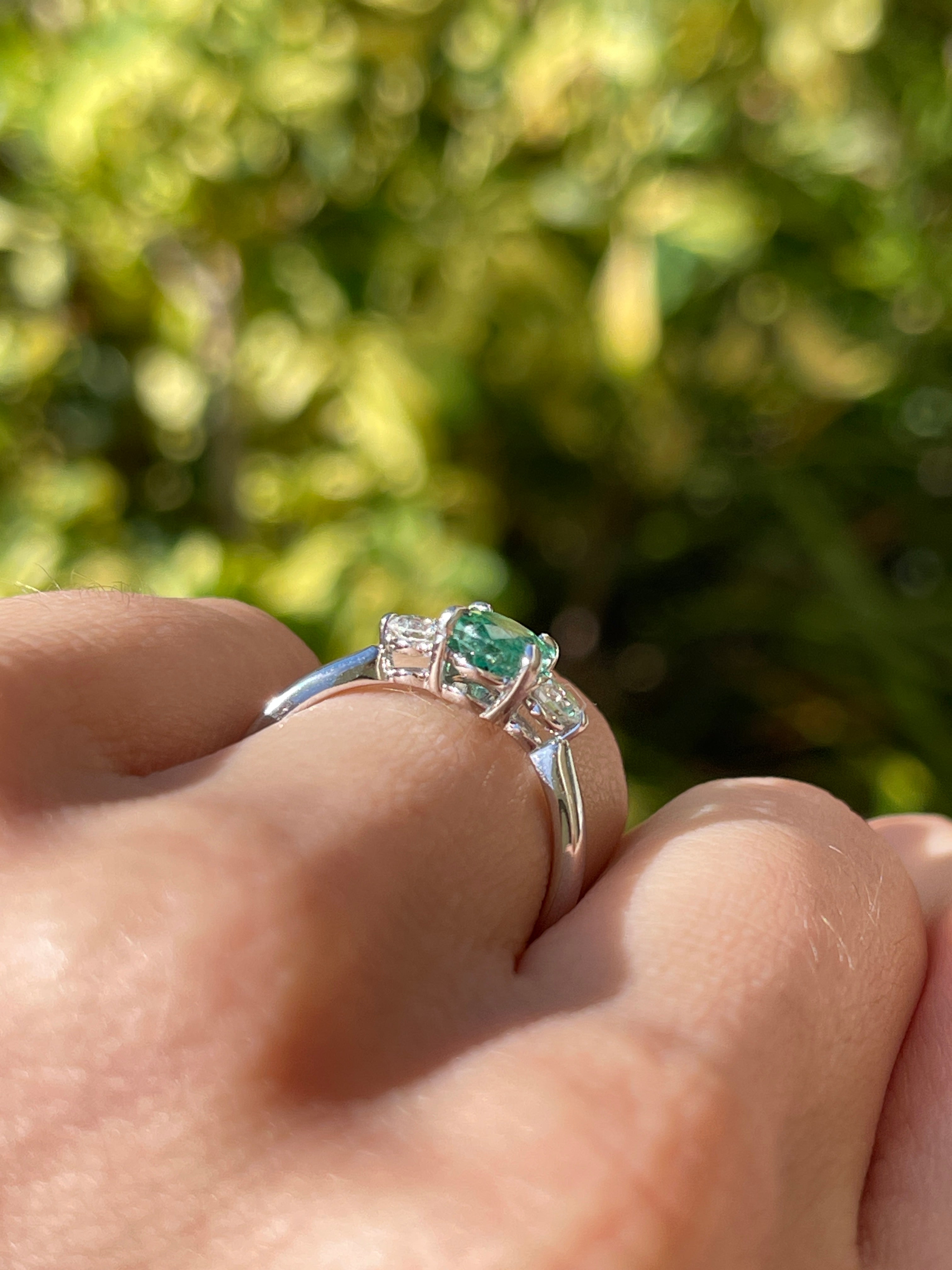 14K natural bluish-green oval cut emerald and round lab diamond three-stone ring by JR Colombian Emeralds, showcasing elegant jewelry design