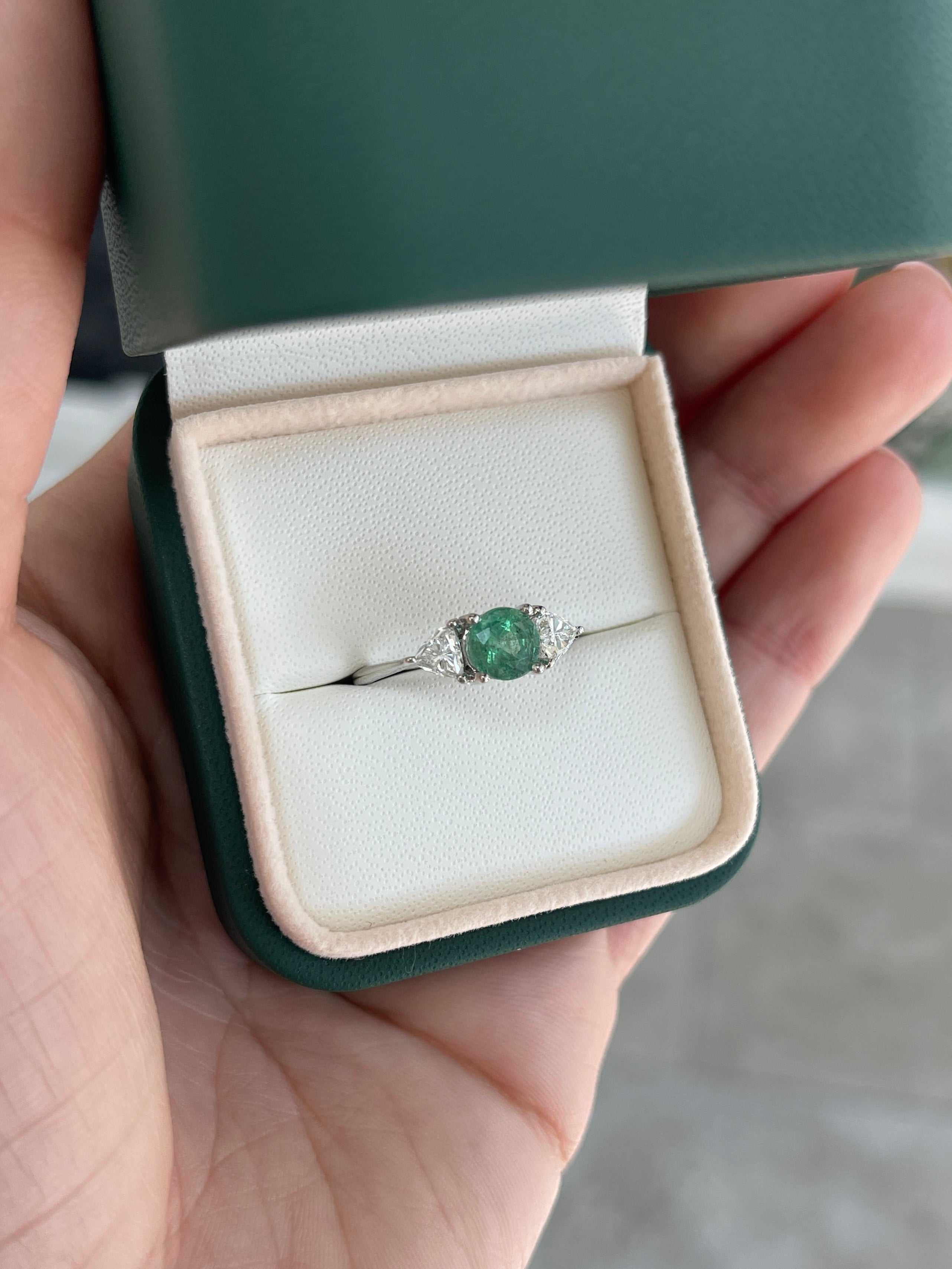 14K gold three-stone ring with 1.70tcw emerald and lab diamond trillion accents, featuring round cut emerald centerpiece.