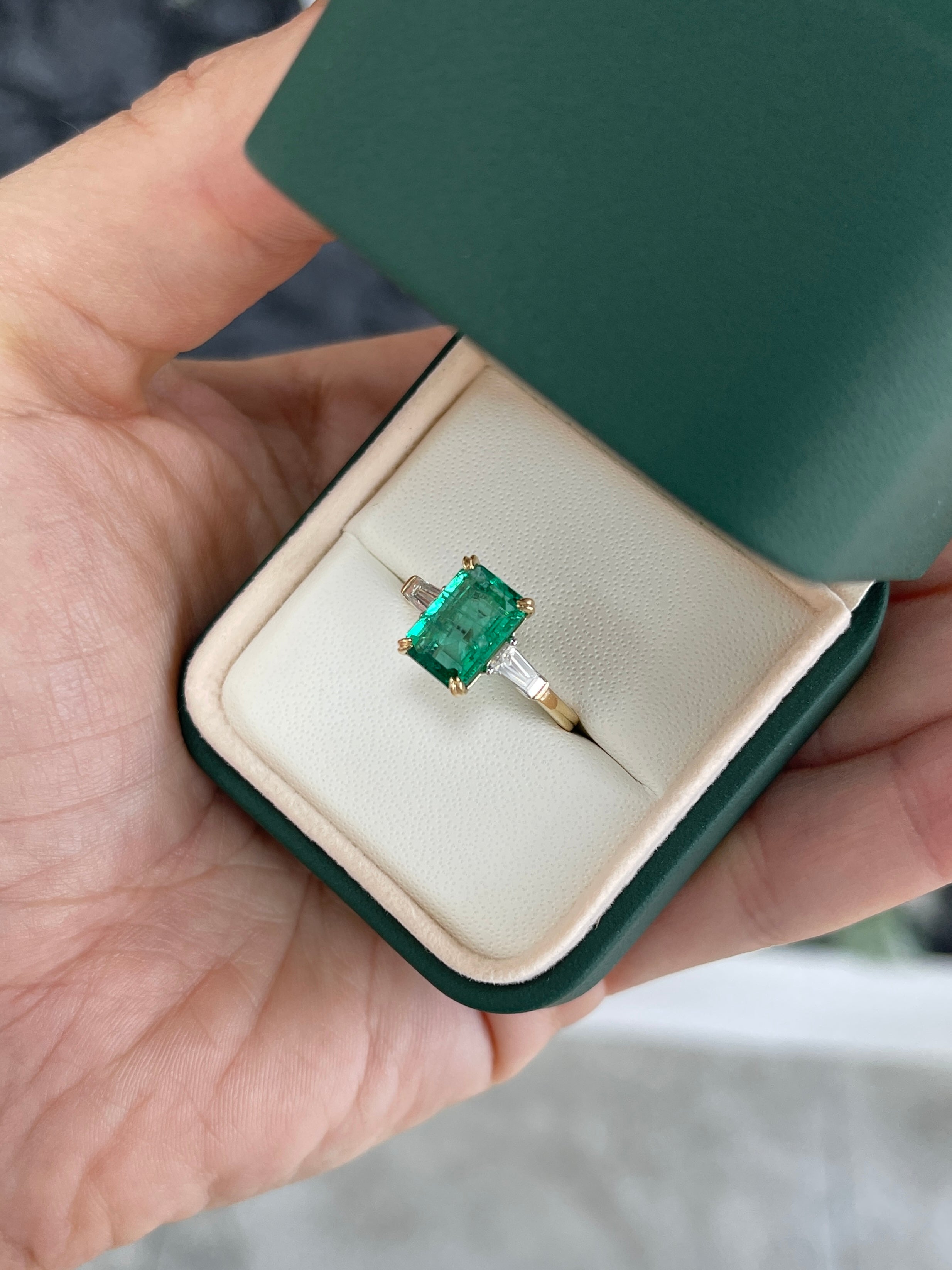14K two-toned emerald cut emerald and baguette diamond three-stone engagement ring by JR Colombian Emeralds, showcasing elegant gemstone design.