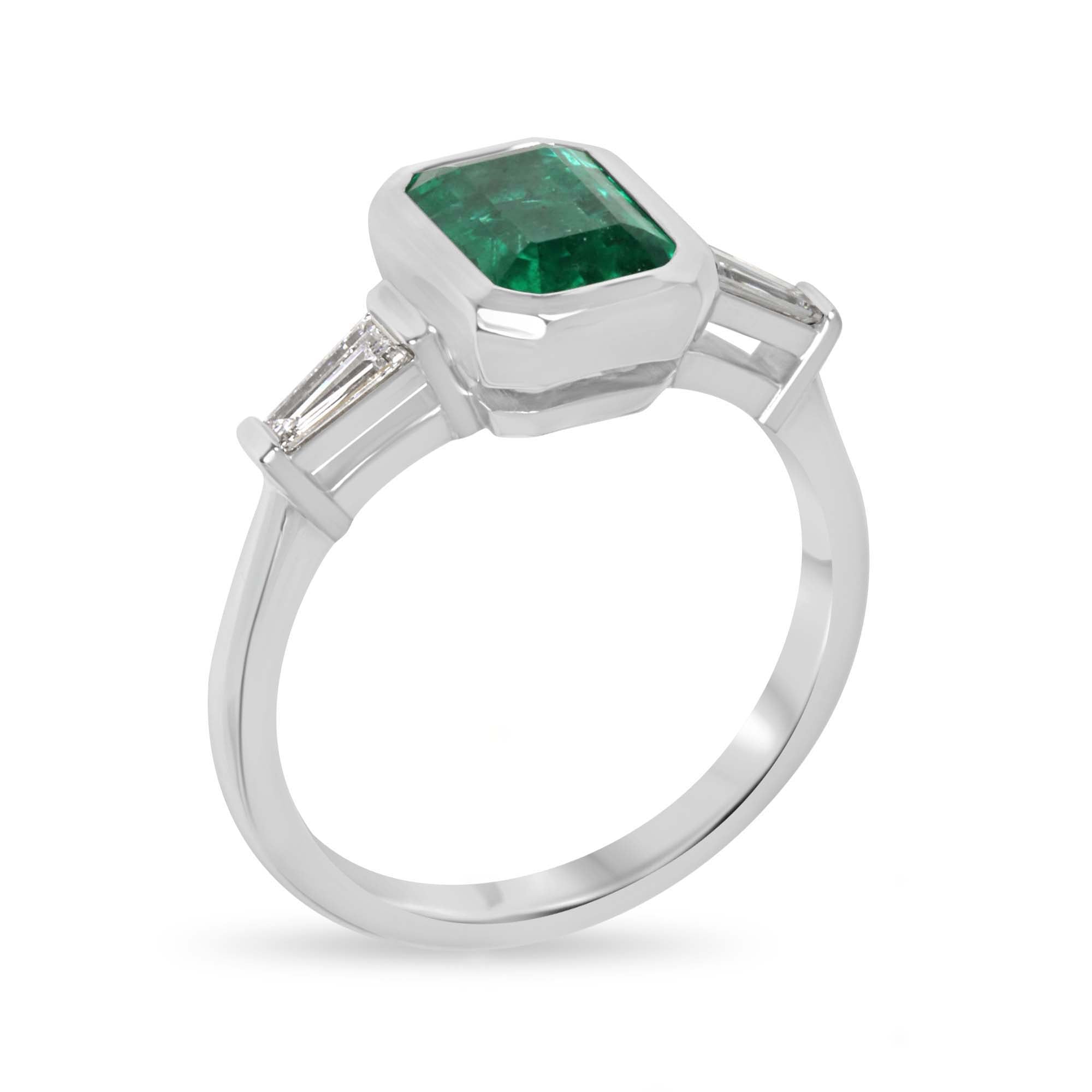 14K natural emerald and lab diamond three-stone engagement ring featuring vivid emerald-cut emeralds and tapered baguette diamonds.