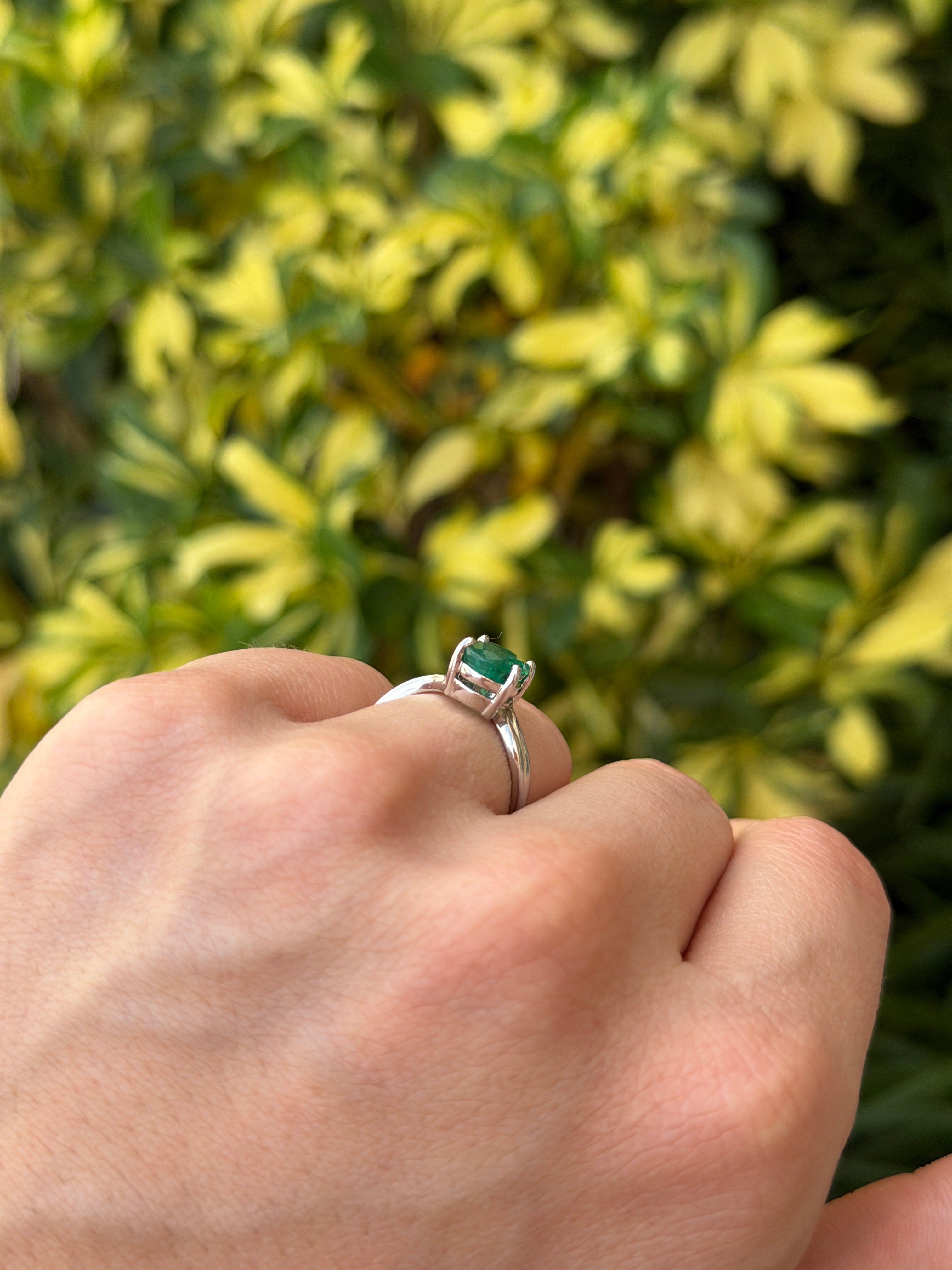 Natural 2.05ct oval emerald solitaire wave ring in 14K white gold, showcasing a vibrant green emerald with elegant band details.