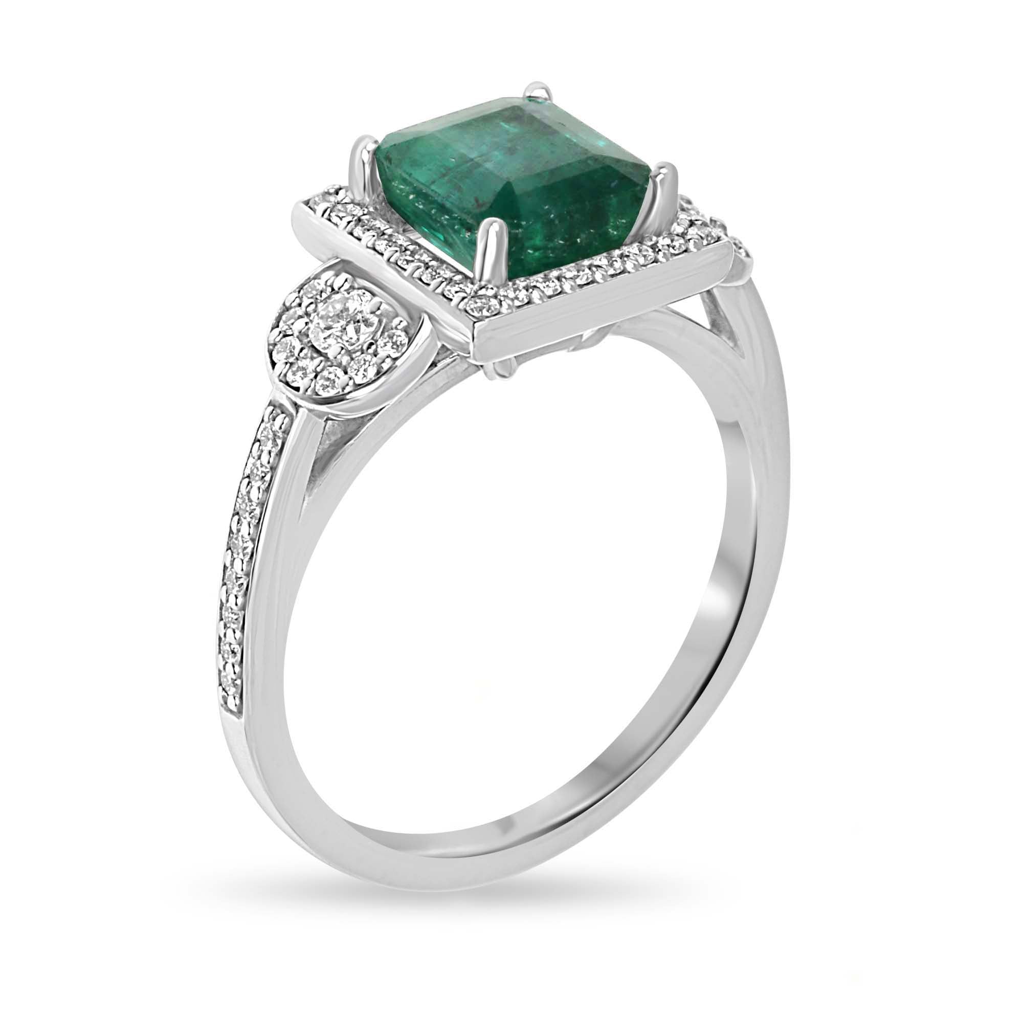 14K gold engagement ring with a rich green Asscher emerald center stone, surrounded by diamond halo accents.