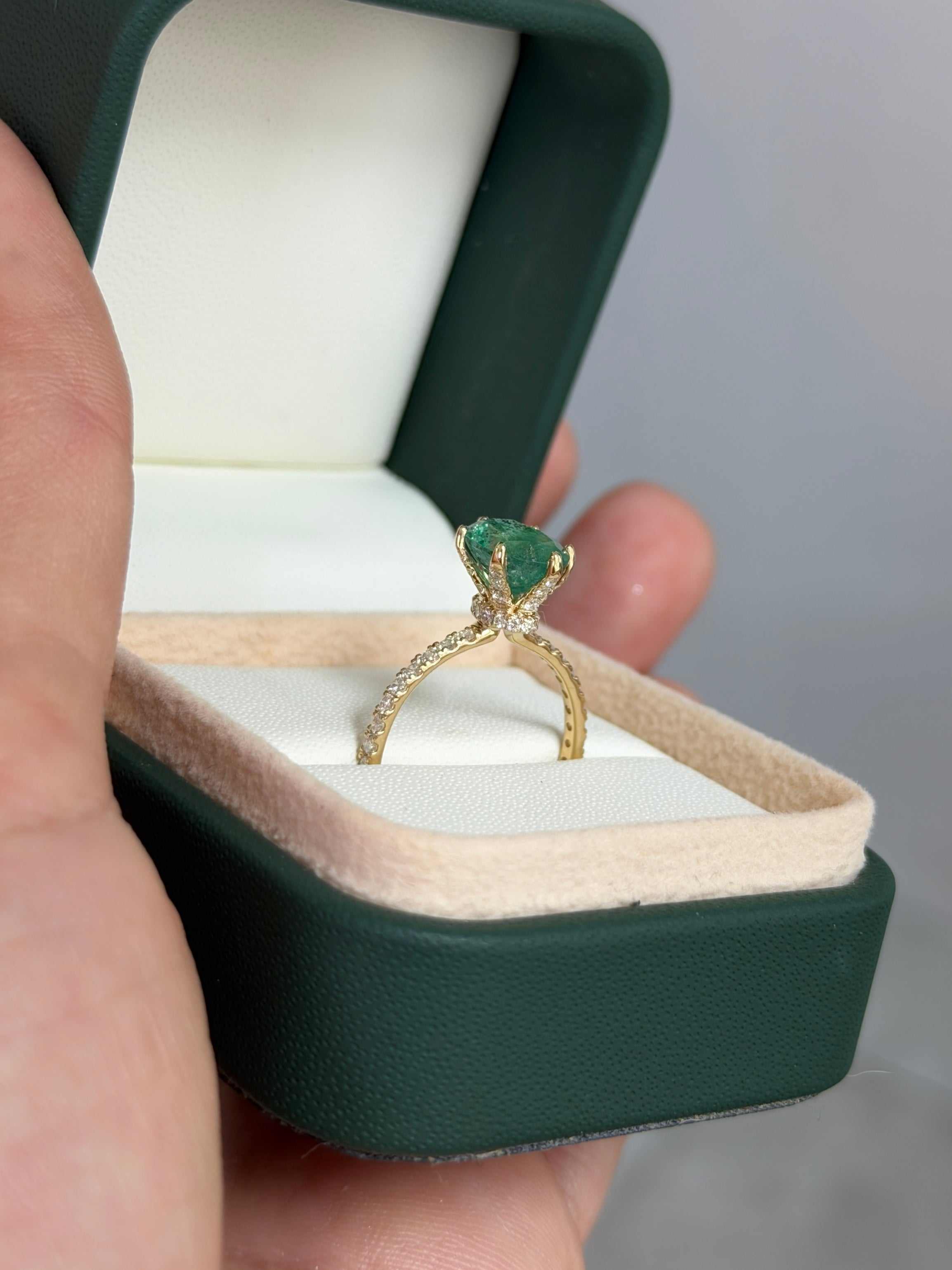 Natural oval emerald and lab diamond accented engagement ring in 14K gold, featuring 2.40tcw of gemstones and freckled emerald details.