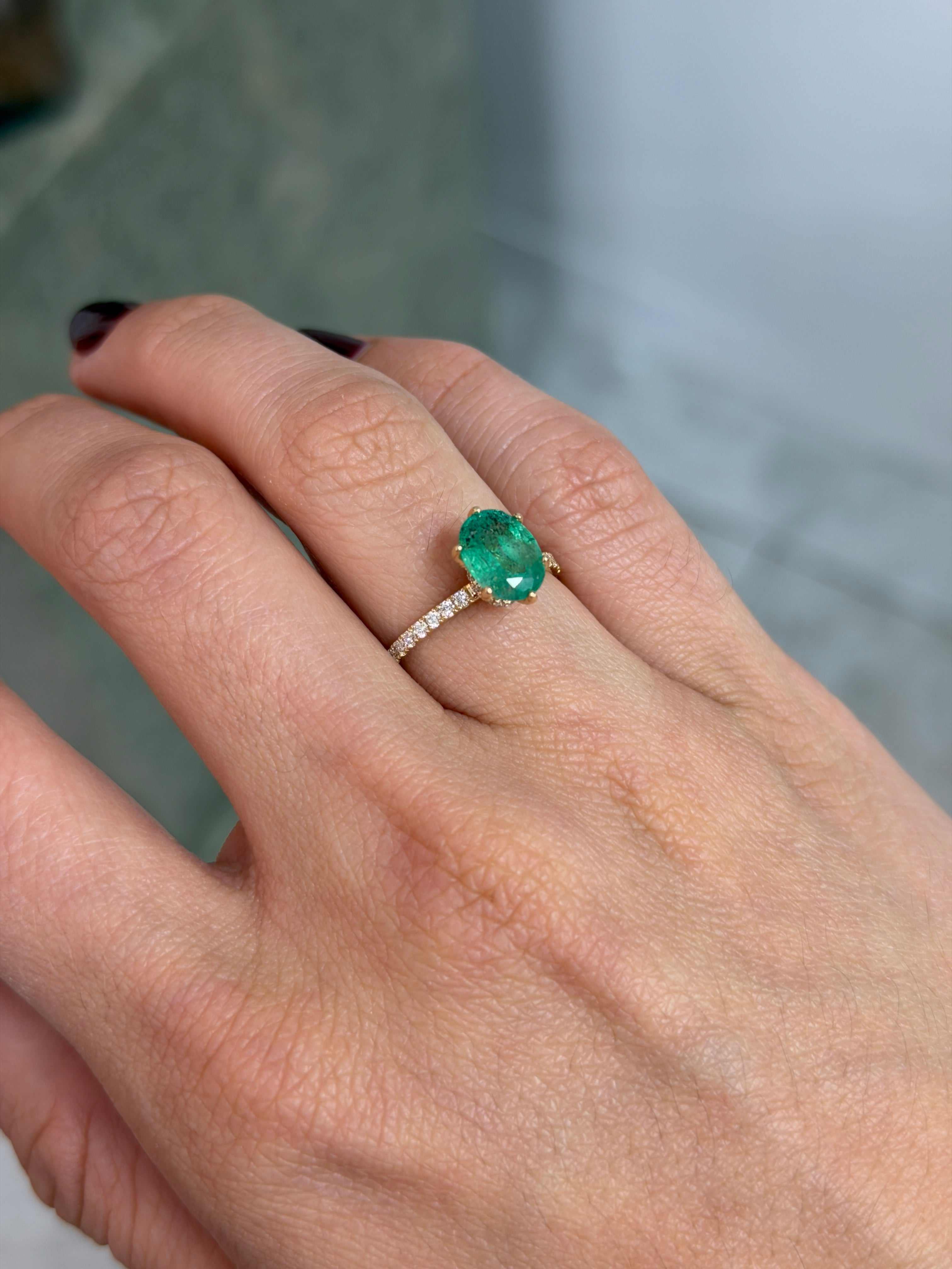 Natural oval freckled emerald engagement ring with lab diamond accents in 14K gold, featuring 2.40tcw of elegant gemstones.