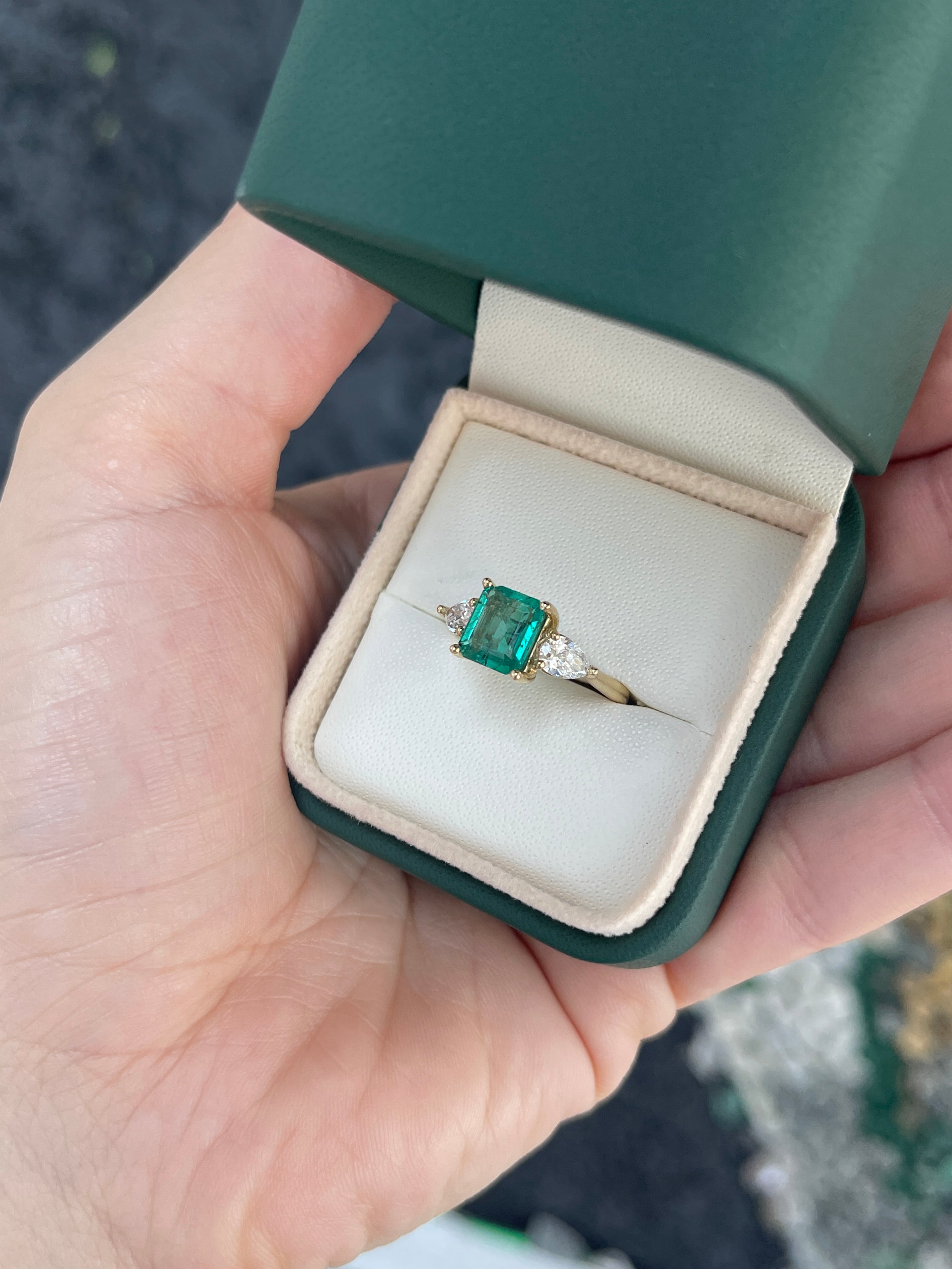 14K natural freckled emerald and lab diamond three-stone engagement ring featuring Asscher cut emerald and pear-shaped diamonds.