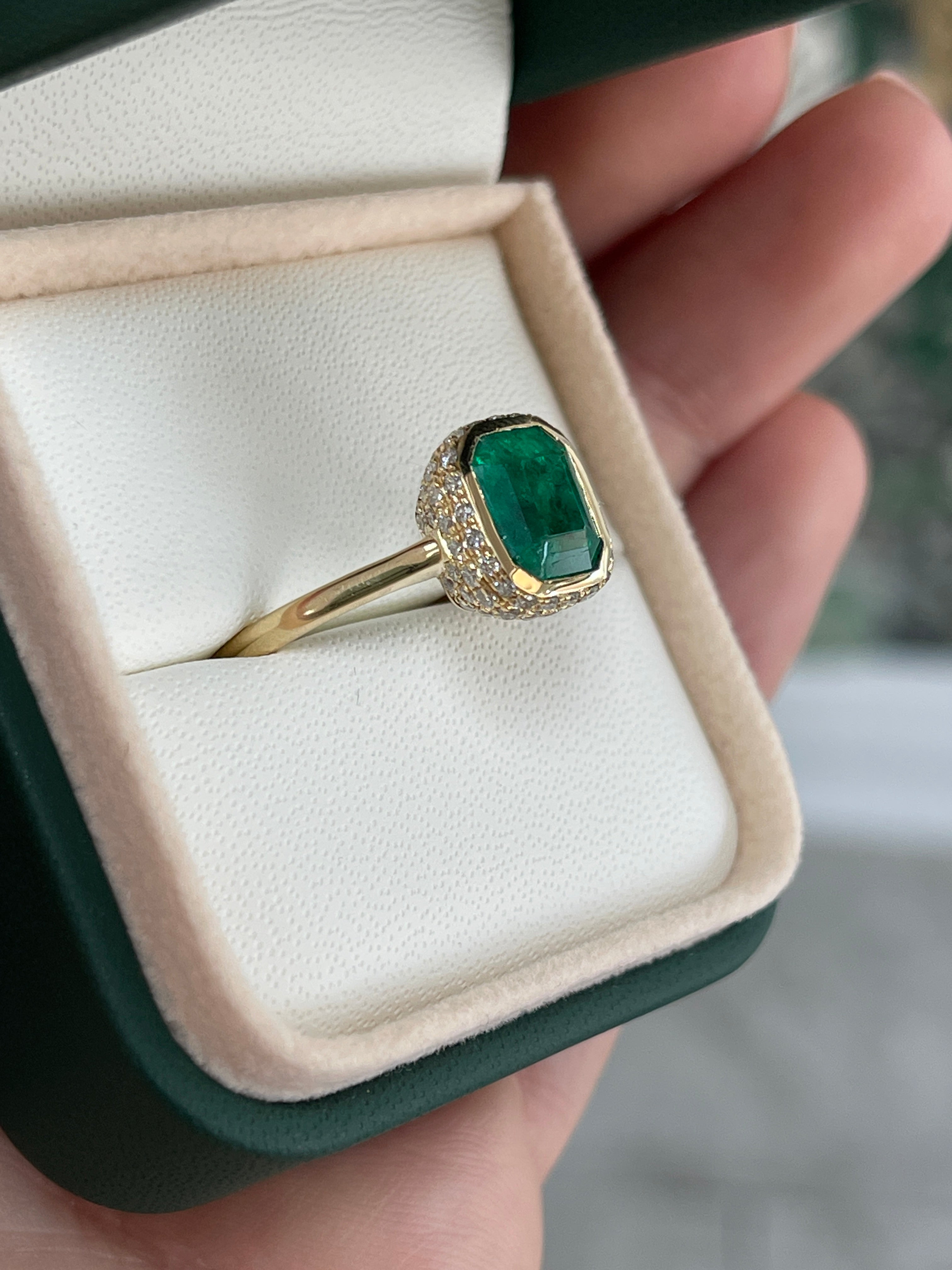 14K Colombian Emerald and diamond pave halo statement ring featuring a 3.19tcw bezel-set emerald by JR Colombian Emeralds.