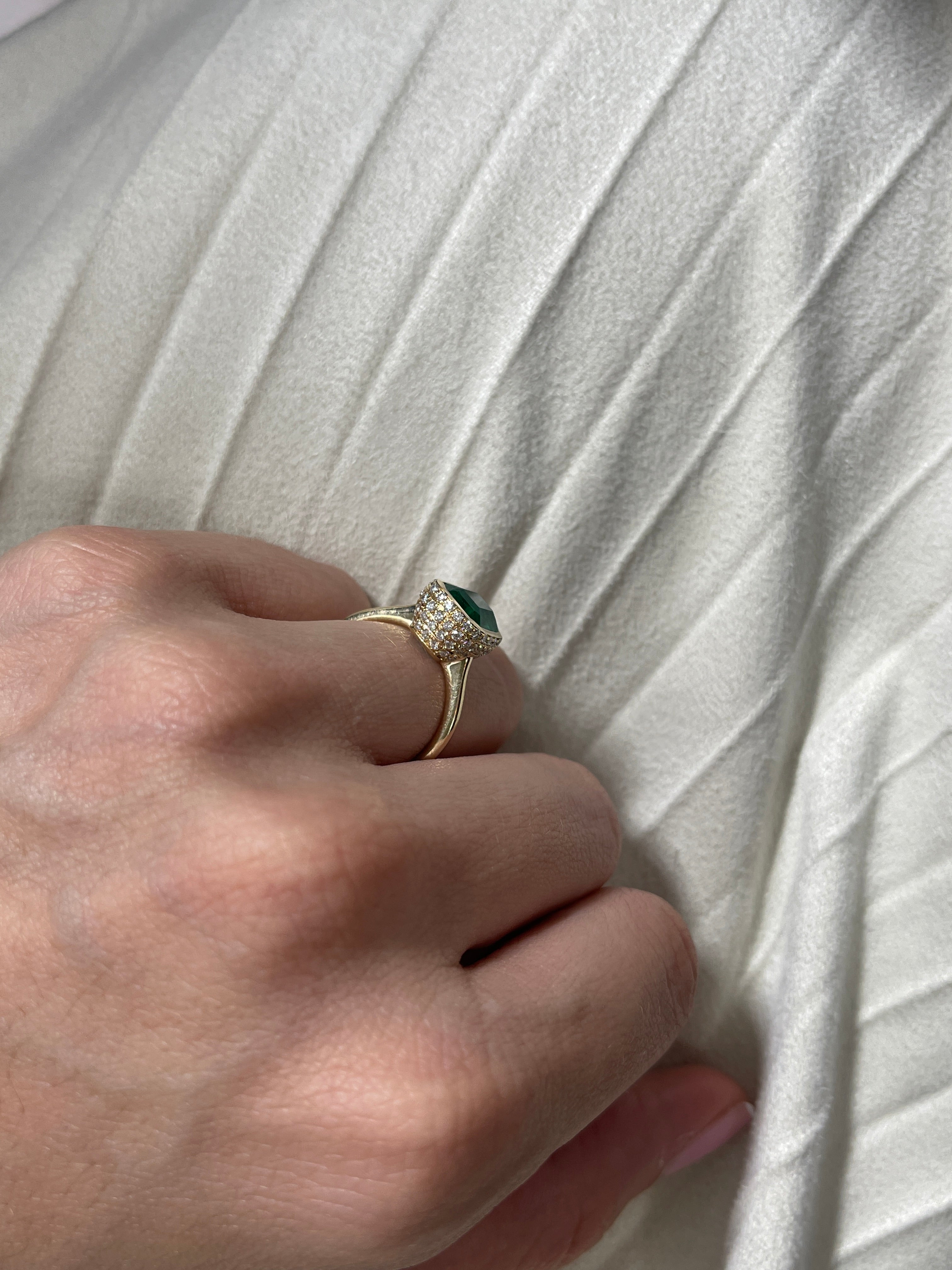 14K Colombian Emerald statement ring with bezel setting, diamond pave hidden halo, showcasing vibrant green gemstones and intricate design.