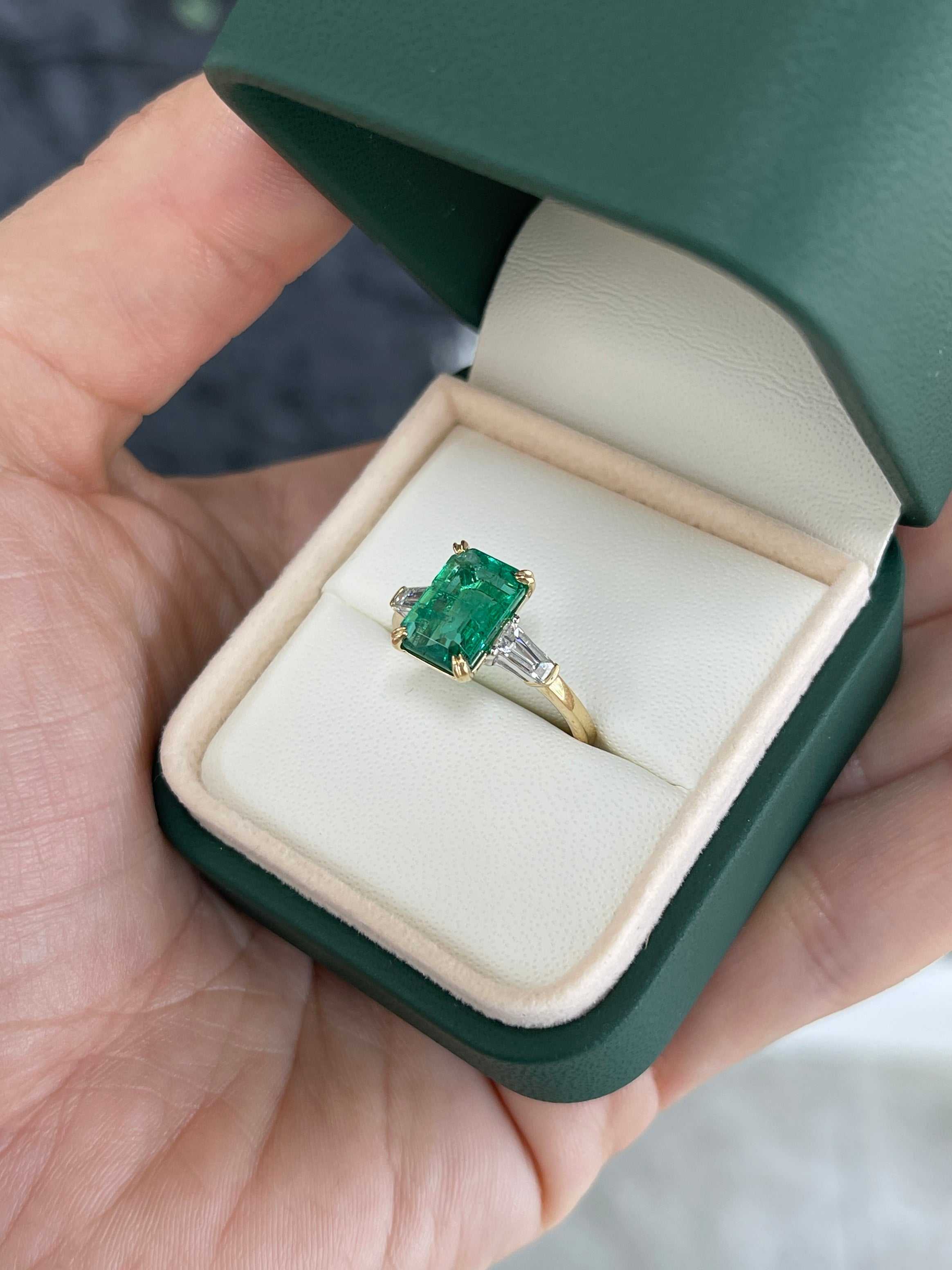 JR Colombian Emeralds 14K two-toned natural emerald cut emerald and baguette diamond three-stone engagement ring.