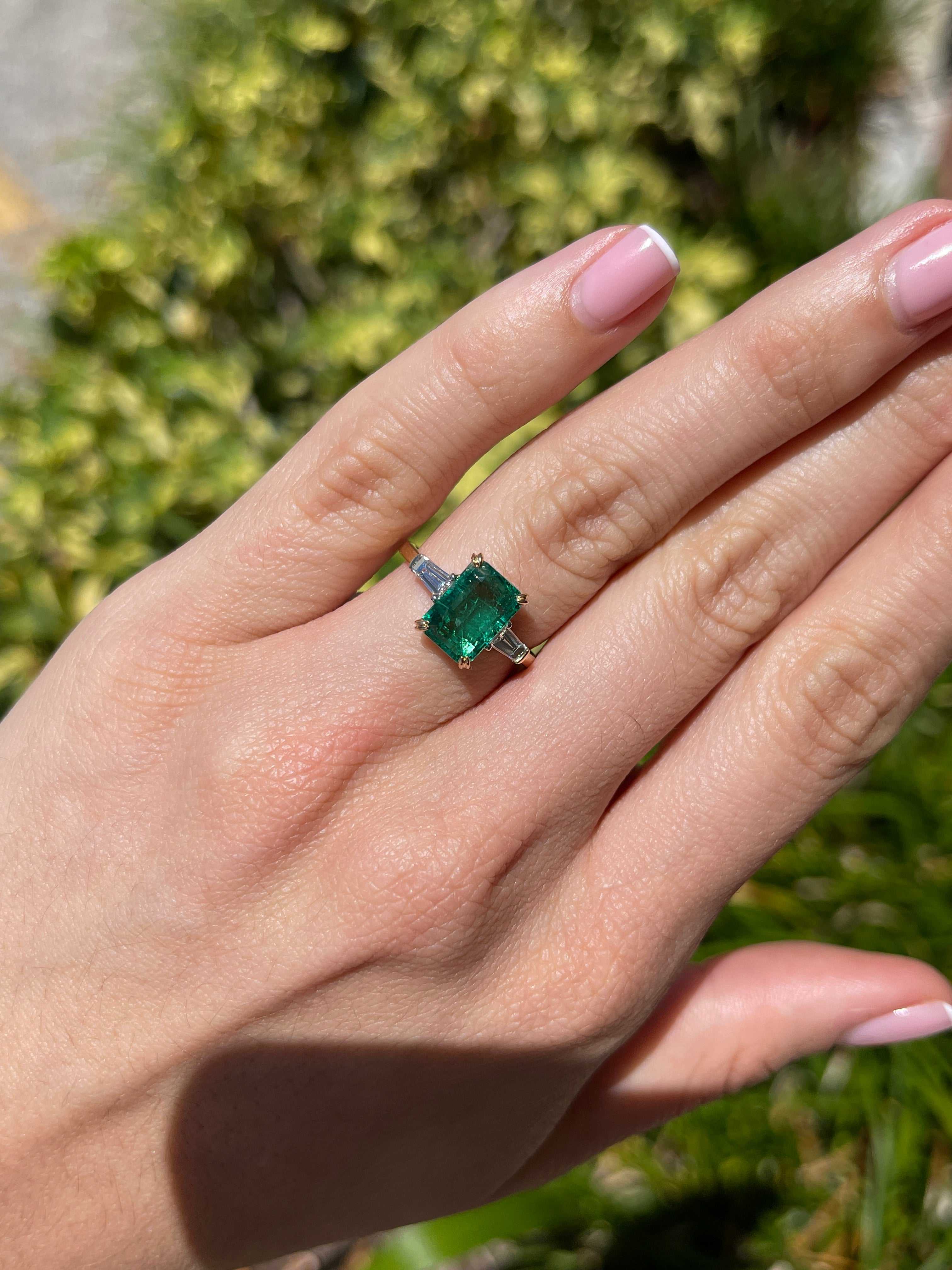 JR Colombian Emeralds 14K two-toned emerald cut emerald and baguette diamond three-stone engagement ring with natural gemstones.