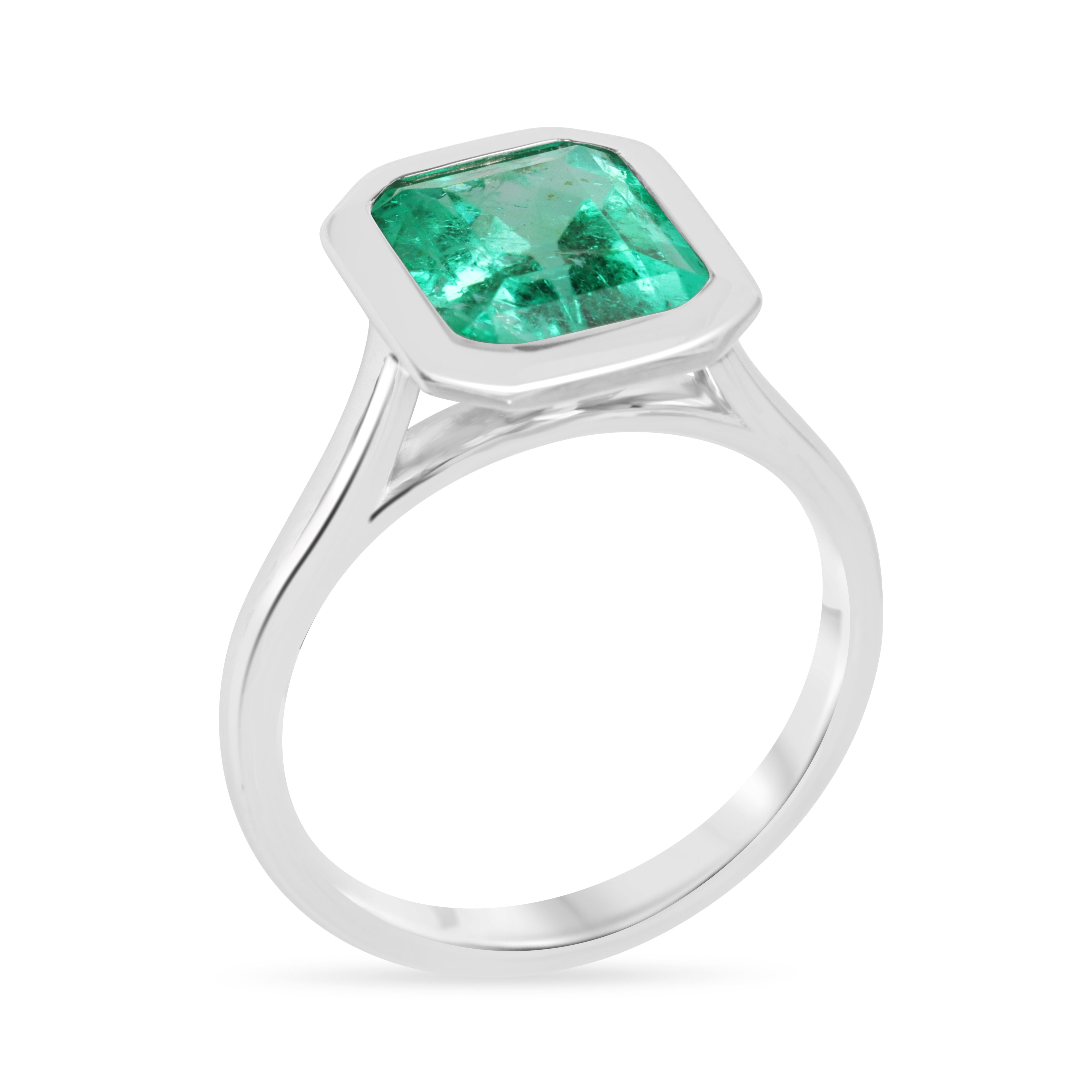 18K white gold ring with a 3.46ct bezel-set Colombian emerald solitaire, featuring vibrant green Chivor emerald from JR Colombian Emeralds.