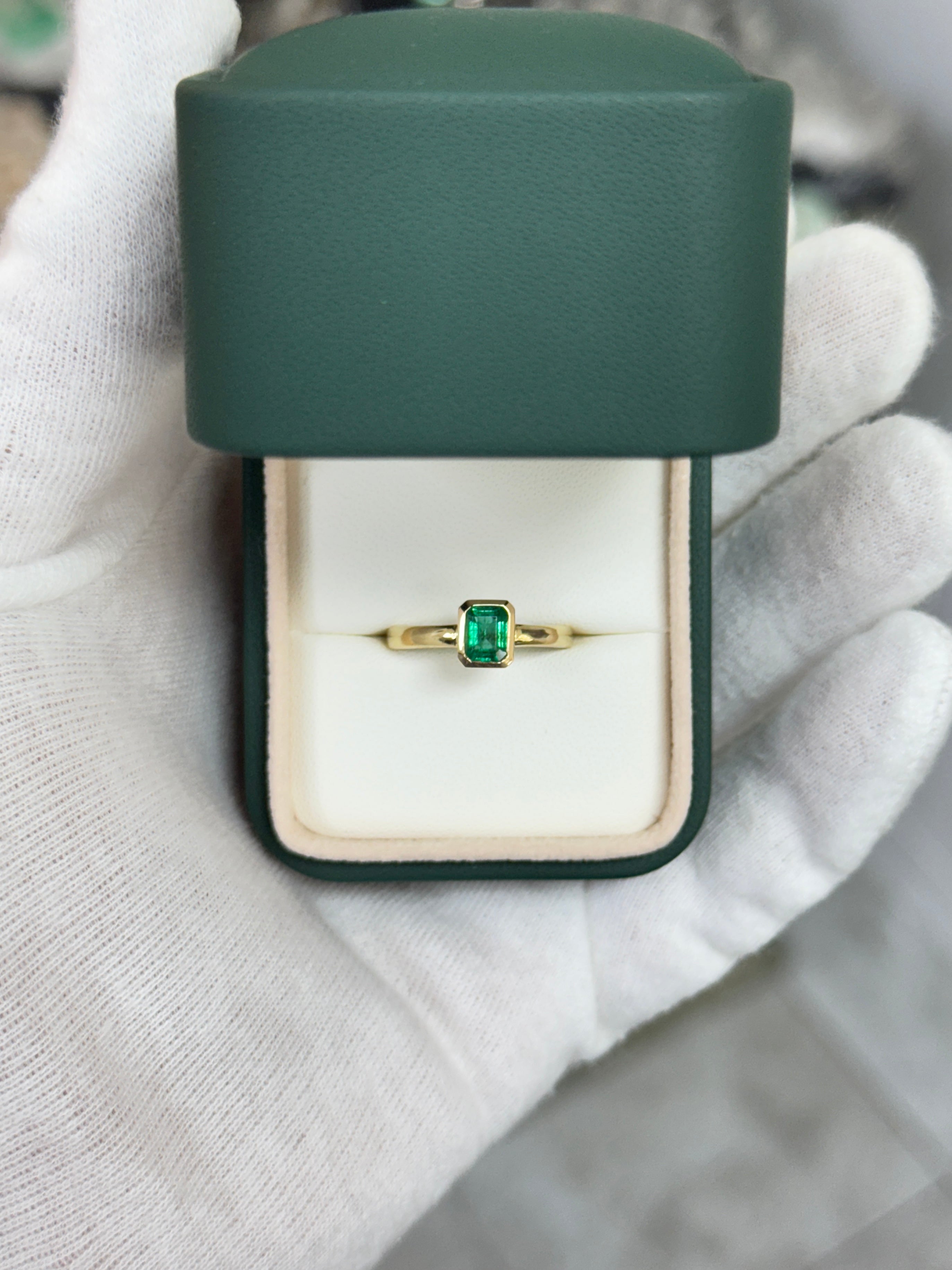 0.90ct bezel set natural emerald ladies ring in 14K gold by JR Colombian Emeralds, showcasing a vibrant green emerald gemstone.