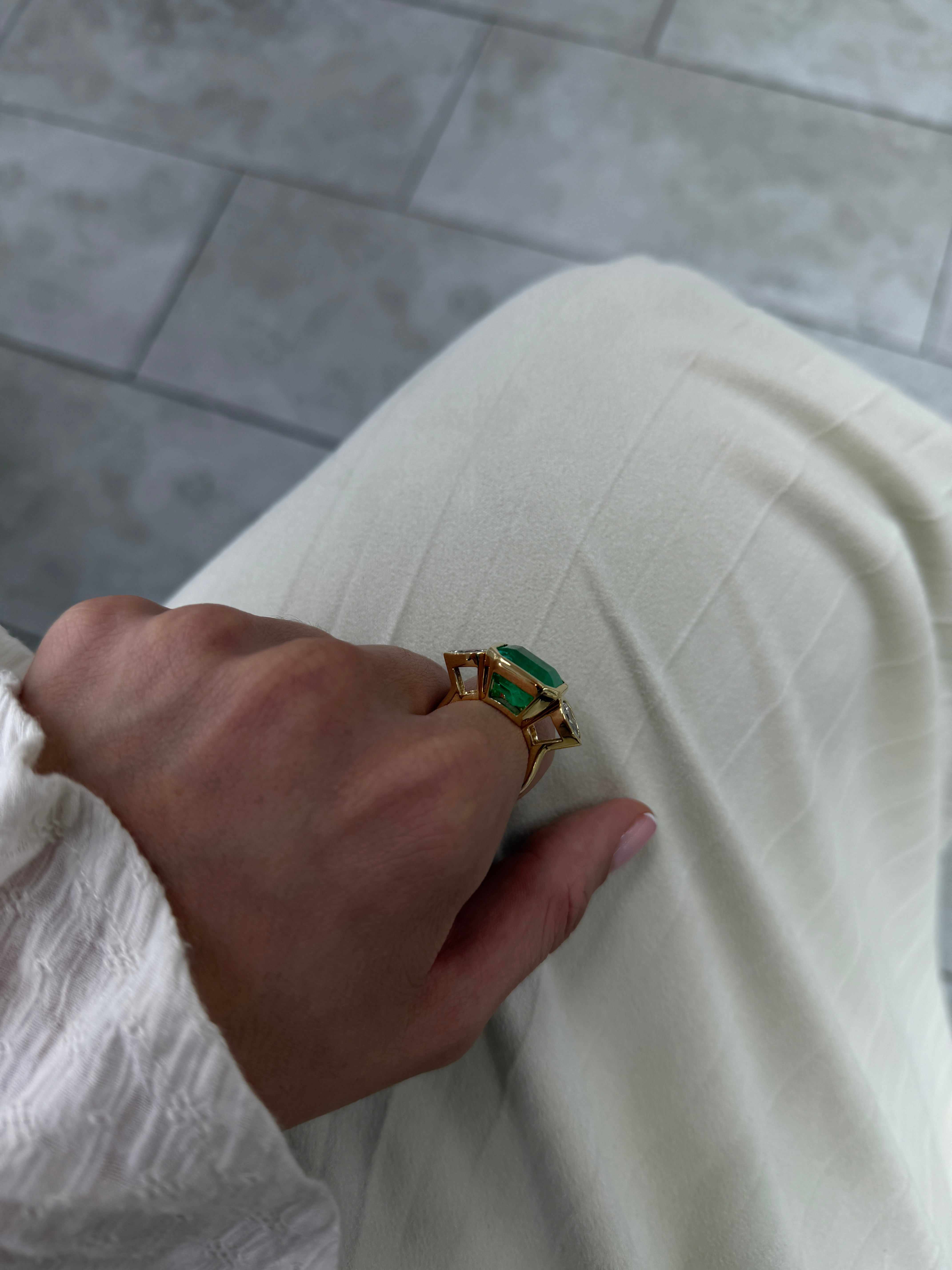 East to West Colombian emerald and pear-shaped diamond three-stone ring in 18K gold by JR Colombian Emeralds.