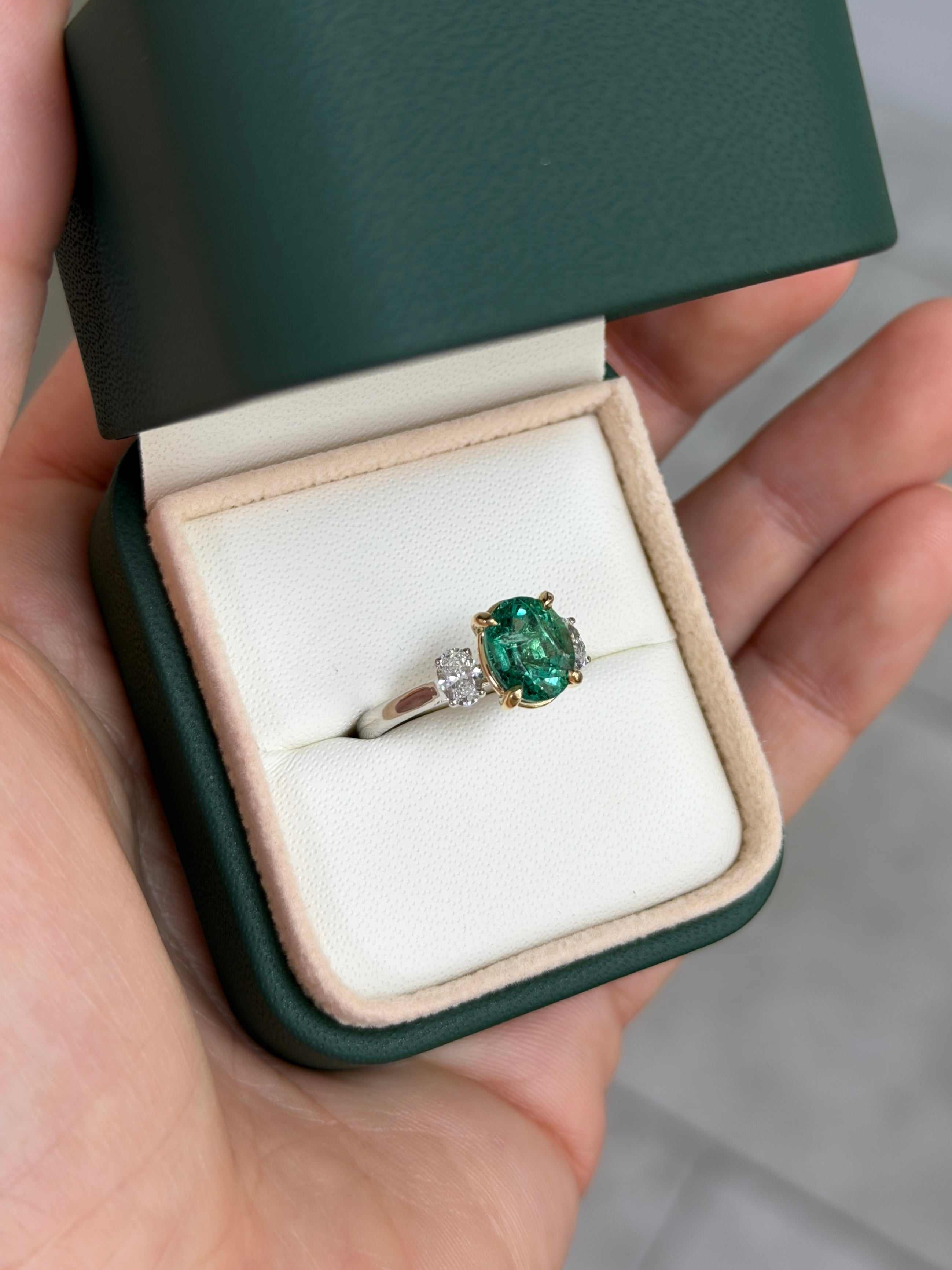 JR Colombian Emeralds 2.19tcw oval emerald and lab diamond three-stone engagement ring in platinum with 14K accents, featuring vibrant gemstones.