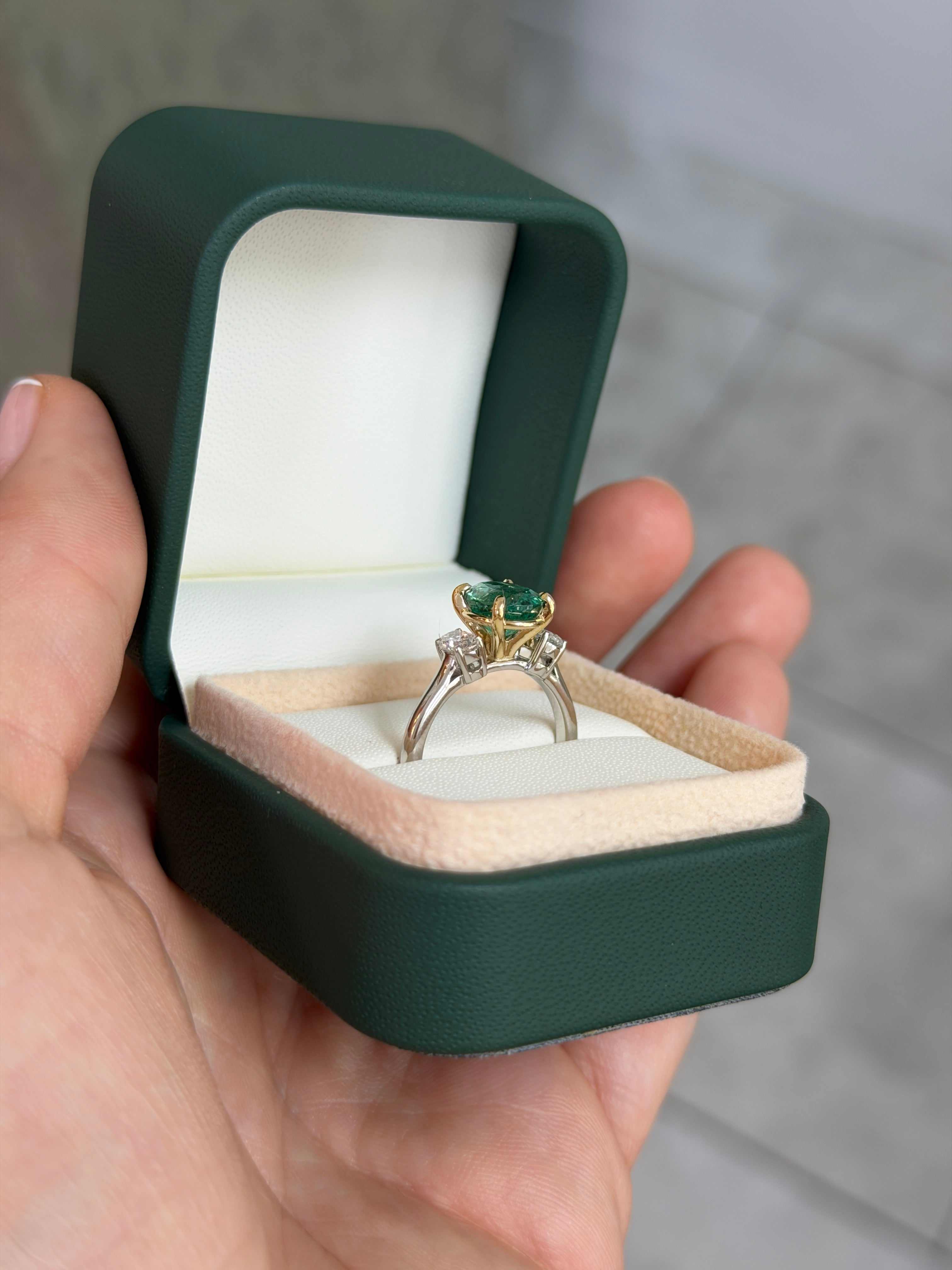 JR Colombian Emeralds 14K gold three-stone engagement ring featuring a vibrant oval emerald and oval lab diamond accents.