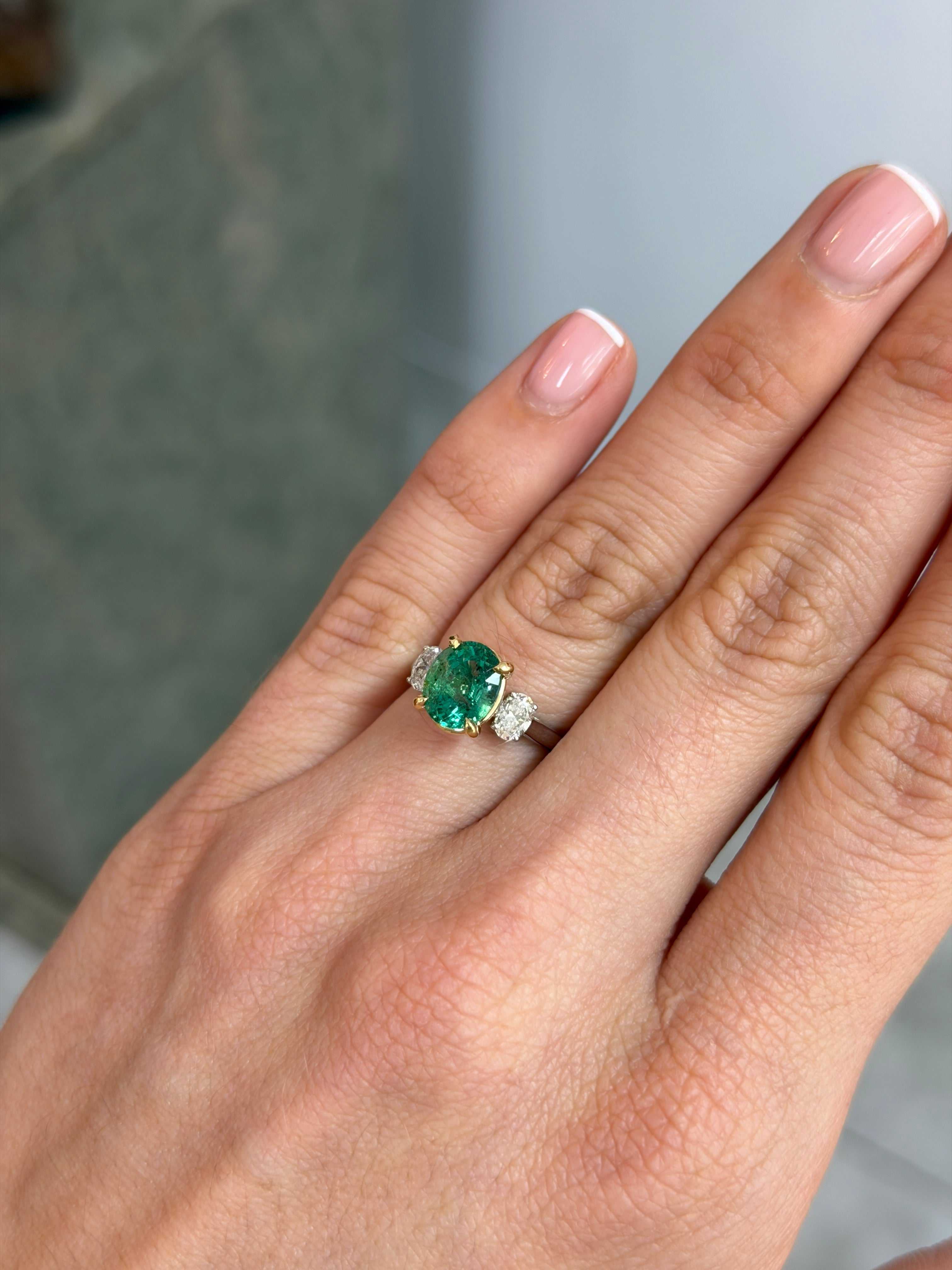 Vibrant oval emerald and lab diamond three-stone engagement ring in 14K platinum by JR Colombian Emeralds.