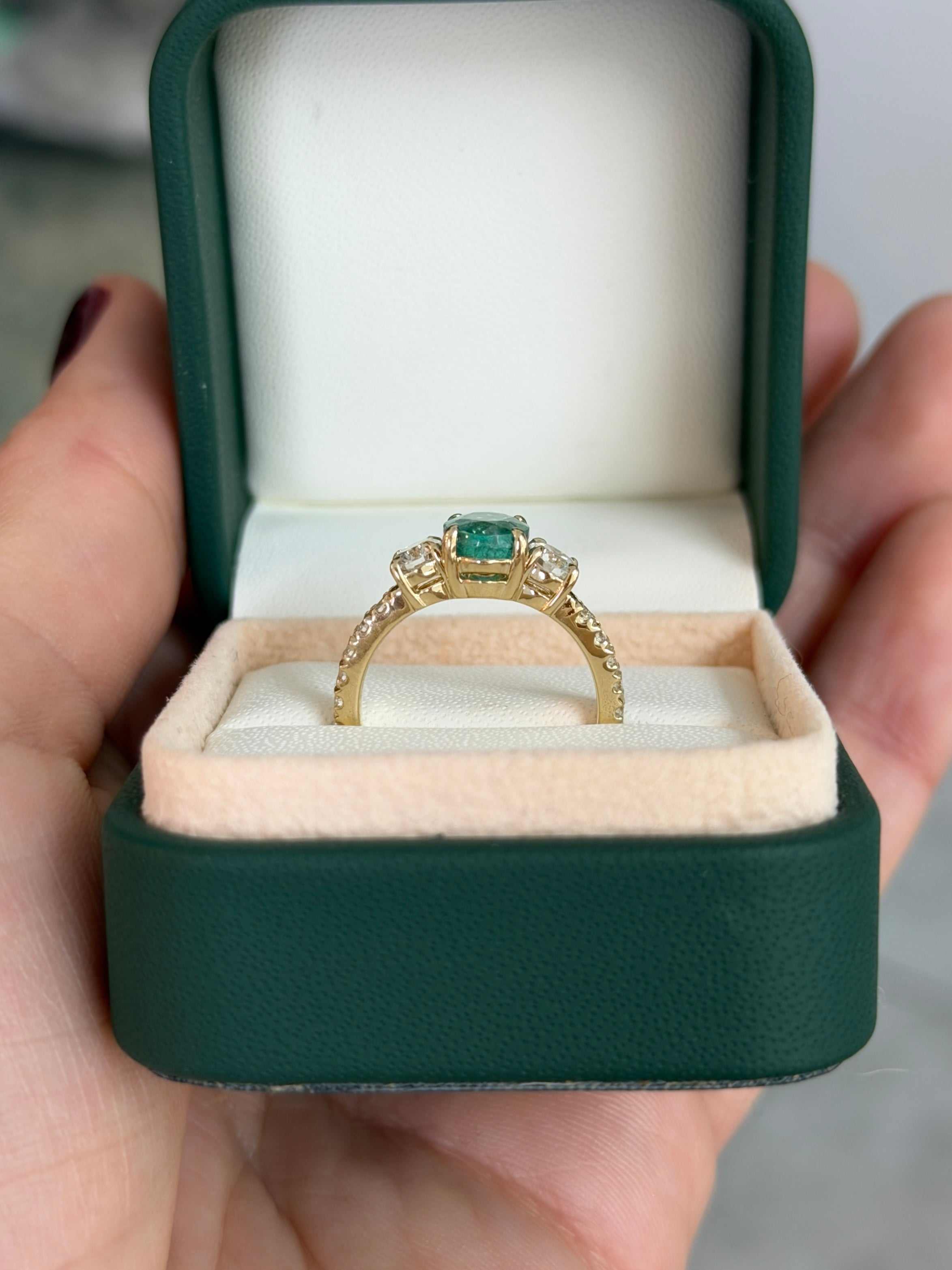 14K gold three-stone ring featuring 2.40tcw oval emerald and round lab diamonds with accent stones, from JR Colombian Emeralds.