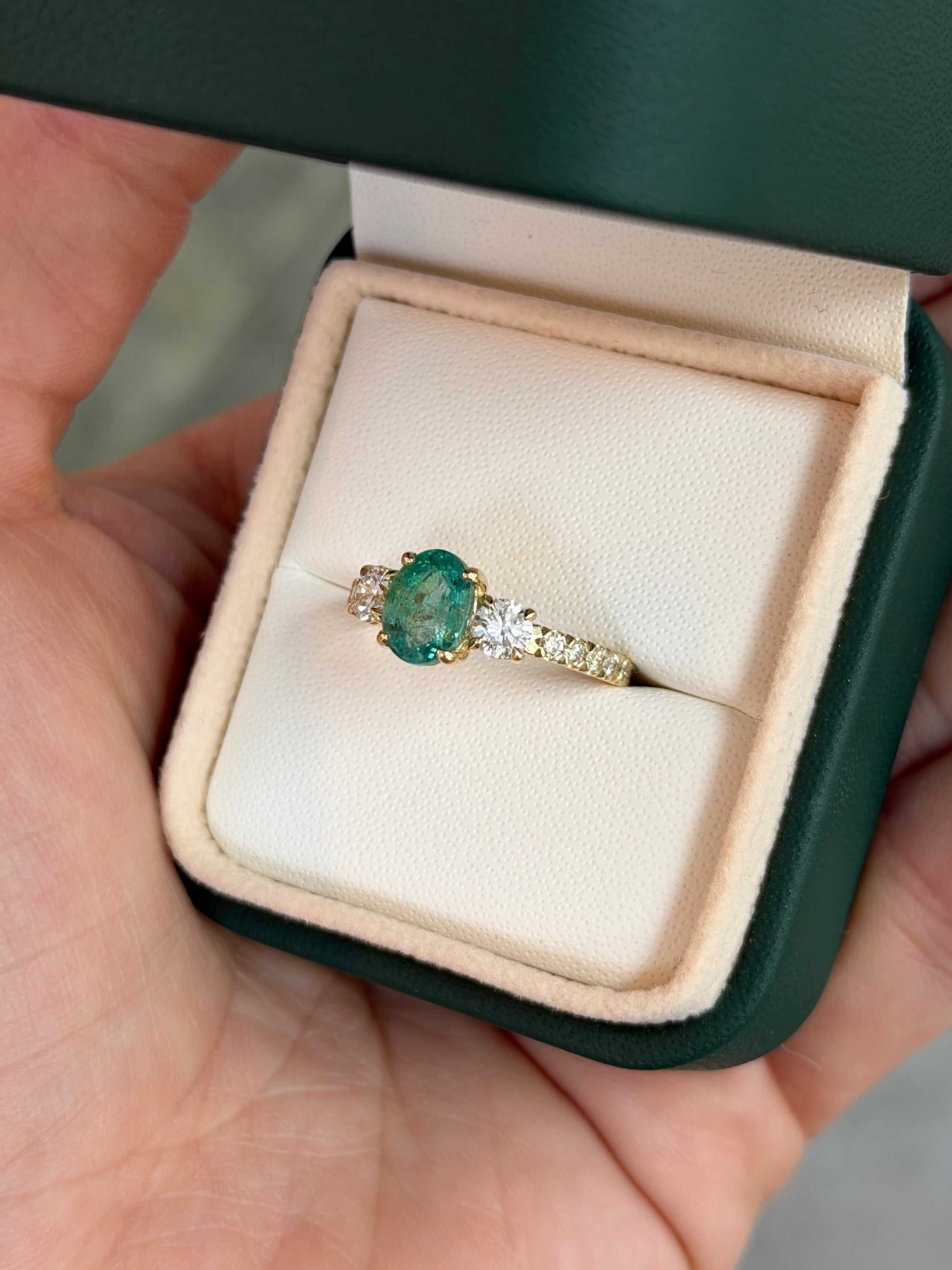 14K gold 2.40tcw oval emerald and round lab diamond three-stone ring with accent diamonds, designed by JR Colombian Emeralds.